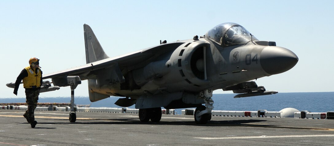 A landing supervisor walks up to an AV-8B Harrier with Marine Medium Helicopter Squadron 261 (reinforced) to give the pilot take-off signals on the flight deck of the U.S.S. Kearsarge during carrier qualifications March 30, 2007. HMM-261 (rein) is scheduled to deploy as the Aviation Combat Element for the 22nd Marine Expeditionary Unit later this year. (Official Marine Corps photo by Sgt. Matt Epright)