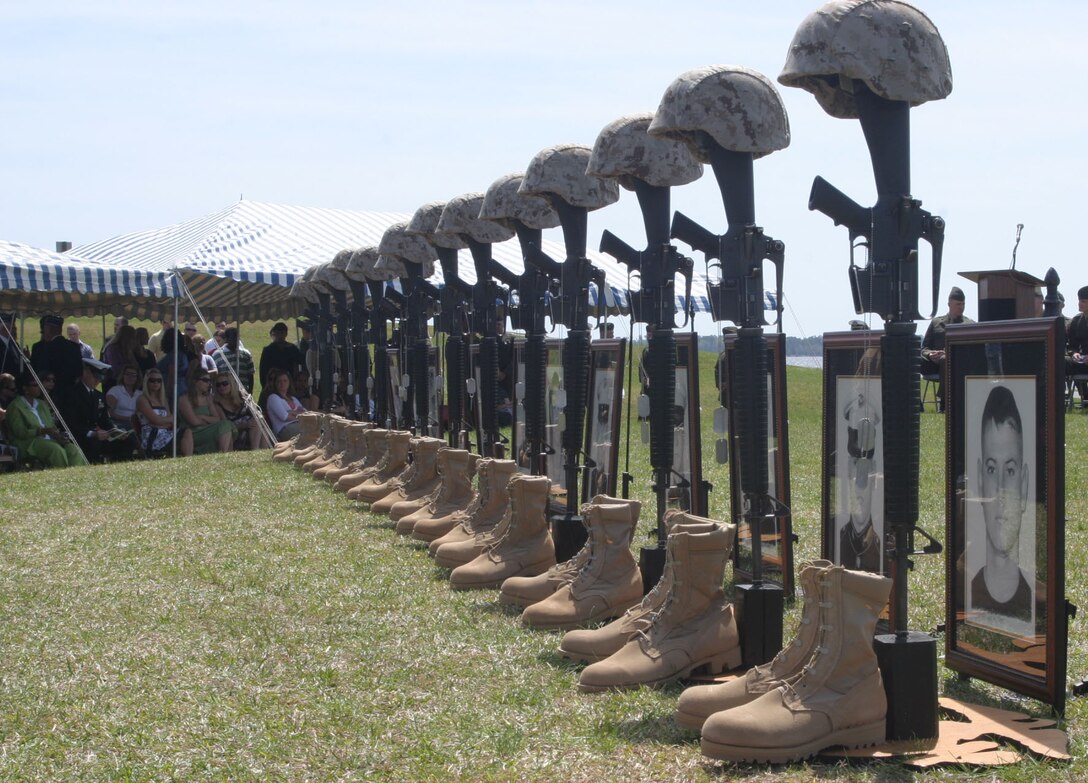 MARINE CORPS BASE CAMP LEJEUNE, N.C.- Fourteen statues of helmets, rifles, dog tags, boots and photographs stand in front of Marines, families and friends of 3rd Battalion, 2nd Marine Regiment, 2nd Marine Division, as they honor their fallen at a memorial ceremony here, March 31. These Marines made the ultimate sacrifice while honorably serving their country in support of Operation Iraqi Freedom in the Al Anbar province of Iraq. (Official U.S. Marine Corps photo by Cpl. Lucian Friel (RELEASED)