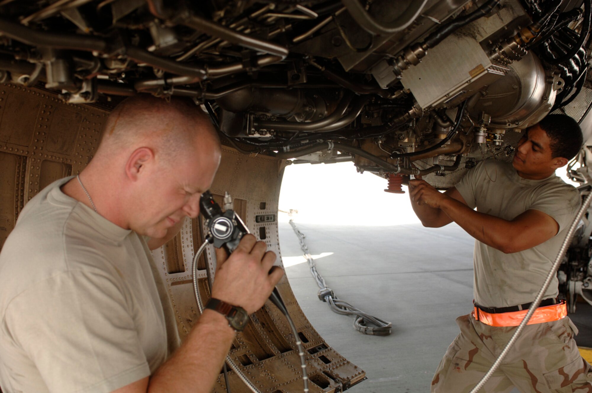 Staff Sgt. Shaun Bennet (left) and Senior Airman Maurice Williams, 379th Expeditionary Aircraft Maintenance Squadron 34th Aircraft Maintenance Unit jet engine technicians inspect B-1B Bomber internal compressor blades during an engine borescope inspection. This inspection is accomplished every 100 engine operating hours. (Photo by Staff Sgt. David Miller)