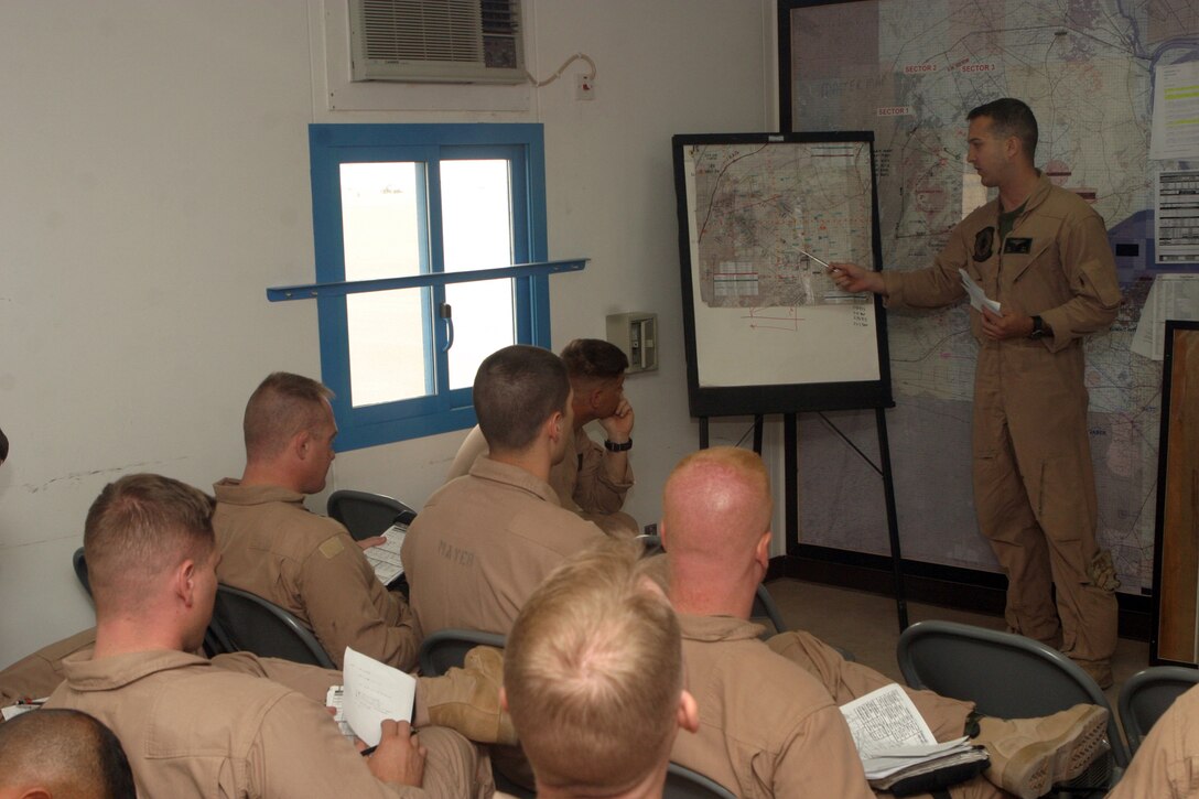 Capt. Justin W. May, a CH-46E Sea Knight helicopter pilot from Marine Medium Helicopter Squadron-264 (Reinforced), 26th Marine Expeditionary Unit, presents a brief during his division leader qualification evaluation at Udairi Range, Kuwait, May 1, 2007.  The evaluation challenged  May's ability to manage not only his aircraft but an additional two CH-46s in a simulated real-world scenario.  (Official USMC photo by Cpl. Jeremy Ross) (Released)