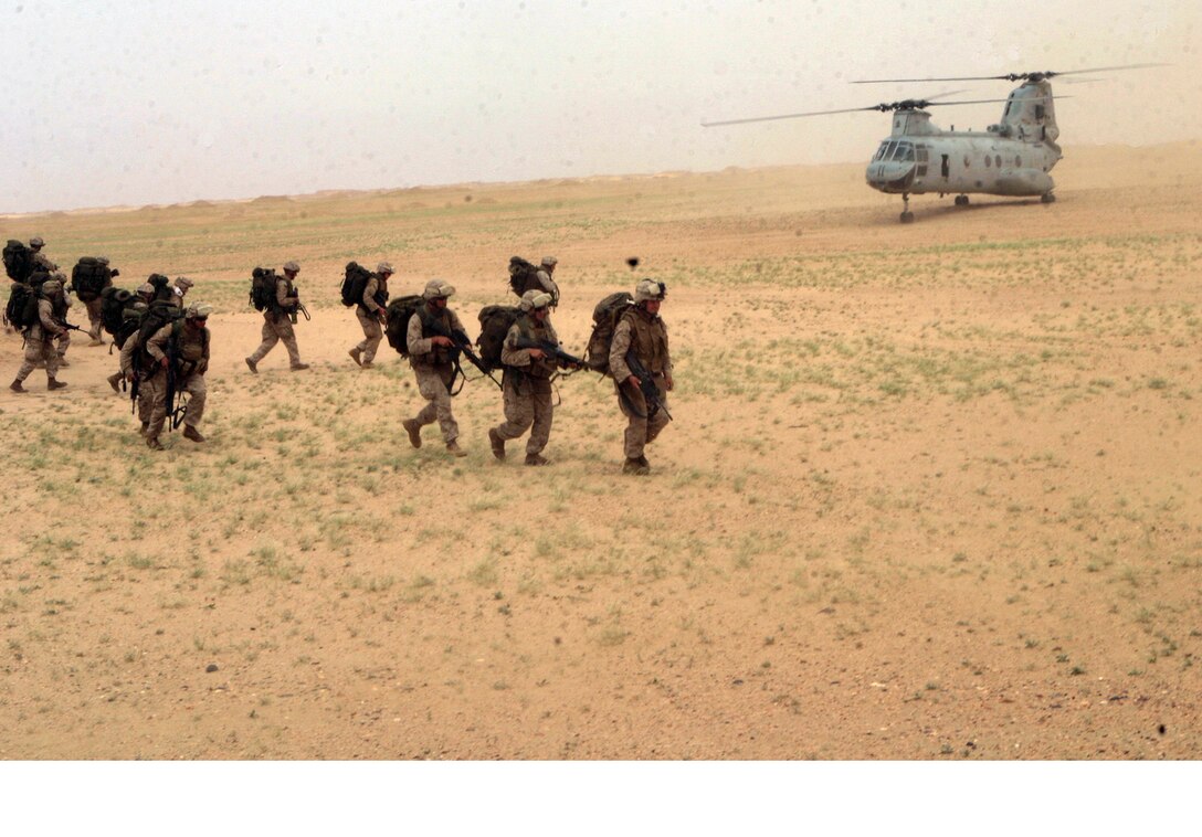 Marines from Scout Sniper Platoon, Battalion Landing Team 2/2, move towards a CH-46E Sea Knight helicopter from Marine Medium Helicopter Squadron-264 (Reinforced), 26th Marine Expeditionary Unit, during a division leader qualification evaluation at Udairi Range, Kuwait, May 1, 2007.  The landing zone for the extraction of the platoon was marked only by a small orange panel, challenging the helicopter pilot being evaluated to locate the LZ.  (Official USMC photo by Cpl. Jeremy Ross) (Released)