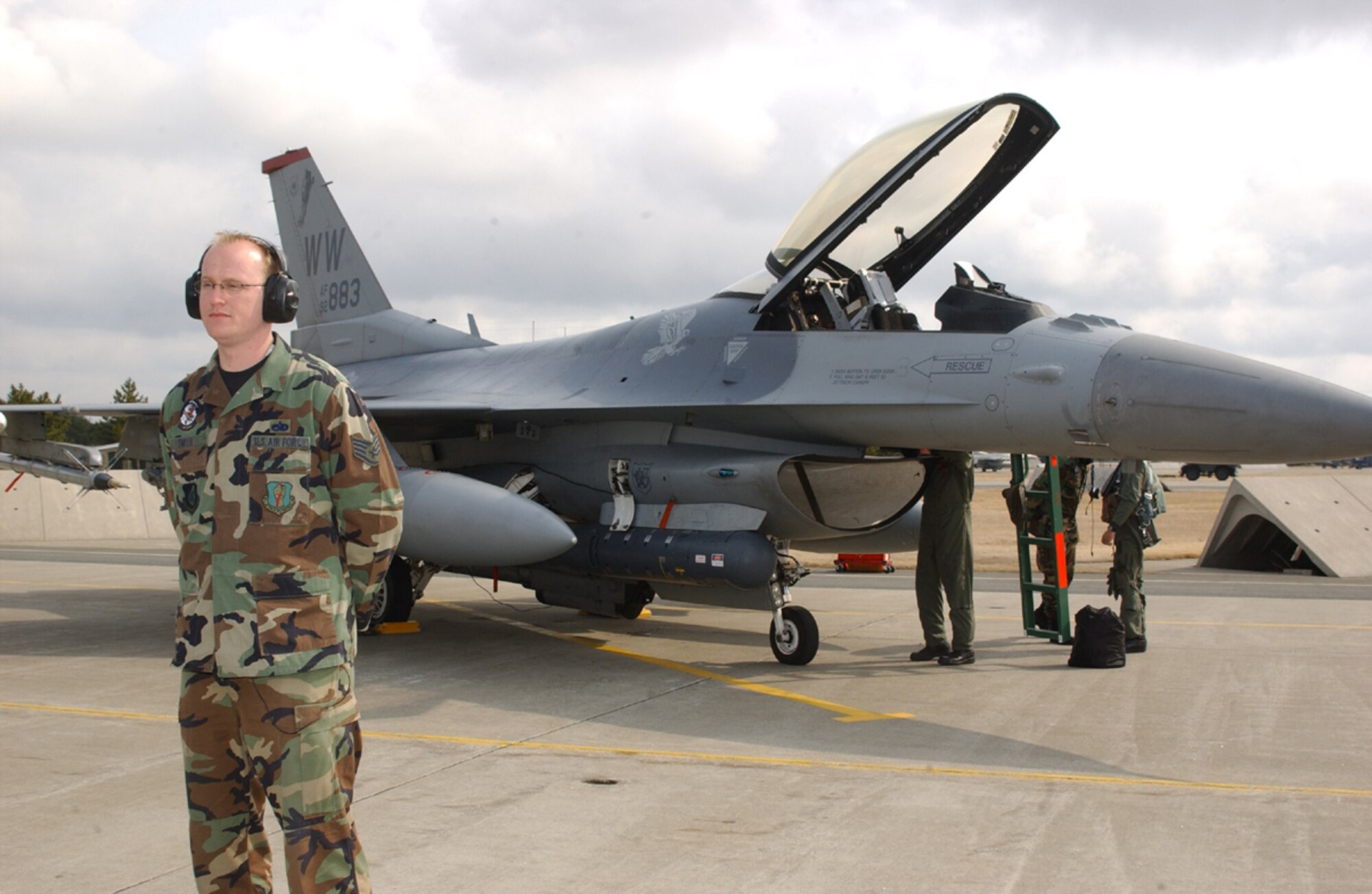 070413-MISAWA AIR BASE, Japan -- Staff Sgt. Christopher Smith, 35th Aircraft Maintenance Squadron, stands by while a 13th Fighter Squadron pilot does his pre-flight check on his F-16 Wild Weasel. (U.S. Air Force photo by Senior Airman Robert Barnett)