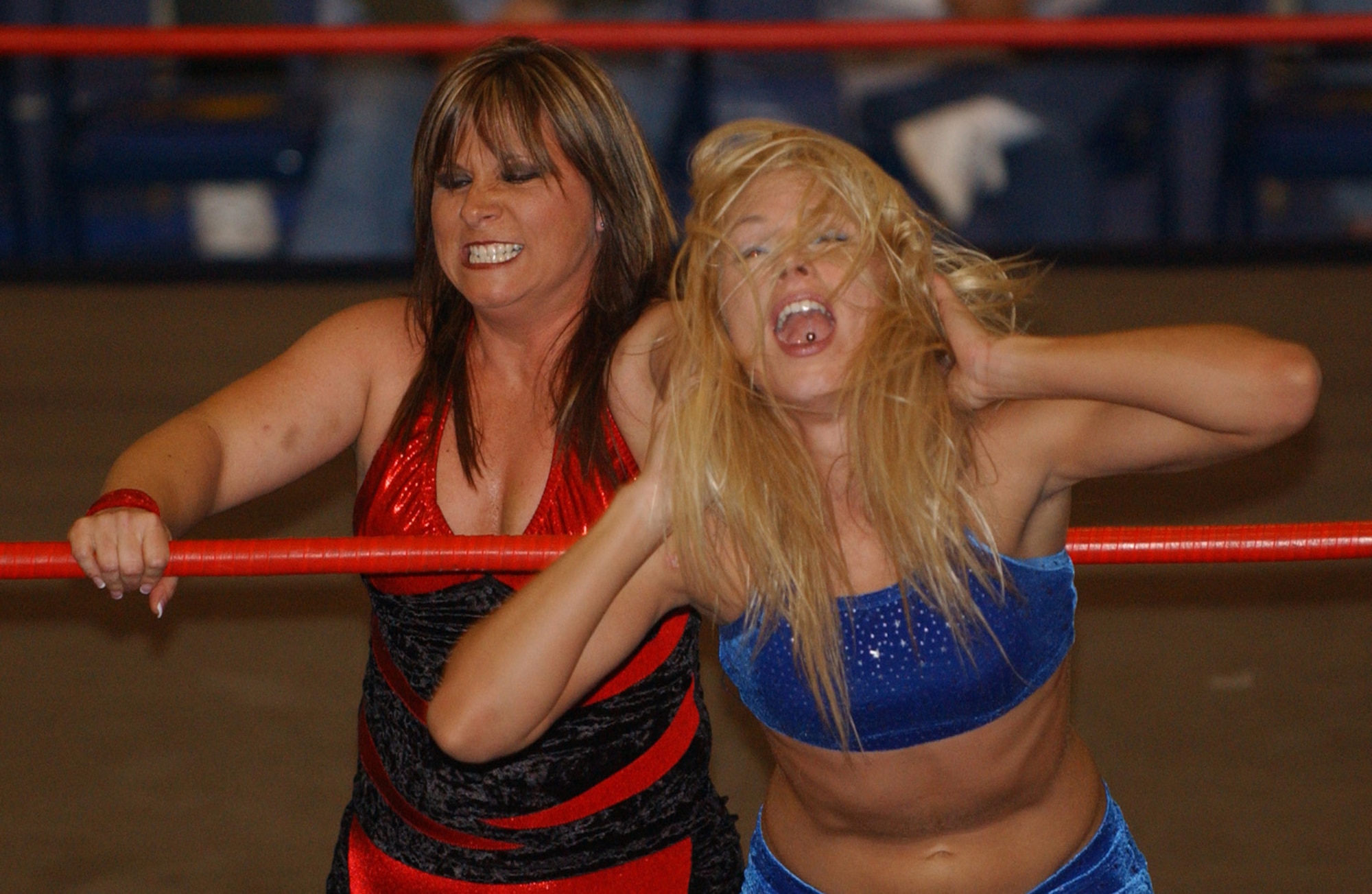 KUNSAN AIR BASE, Republic of Korea  April 29, 2007 --  International Championship Wrestling star Lexie Fyfe grabs opponent Erica D'Erico by the hair just outside the ropes April 29 at the base fitness and sports center. The ICW's 2007 Pacific Invasion tour, sponsored by Armed Forces Entertainment, took the wrestling group to other United States Forces Korea installations, including Chinhae Naval Base, Camp Humphries, Osan Air Base and Camp Red Cloud. The wrestling tour ran from April 12 through May 1.                                                              