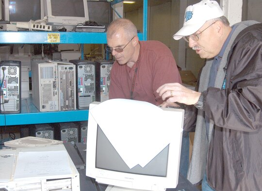 Chief Master Sgt. Mike Conatser, Air Force junior ROTC at East High School, turns in electronic equipment to Chuck Jelinski, 90th Communications Squadron, during the electronics reuse and recycling campaign from Nov. 15 to March 15 (Courtesy photo).