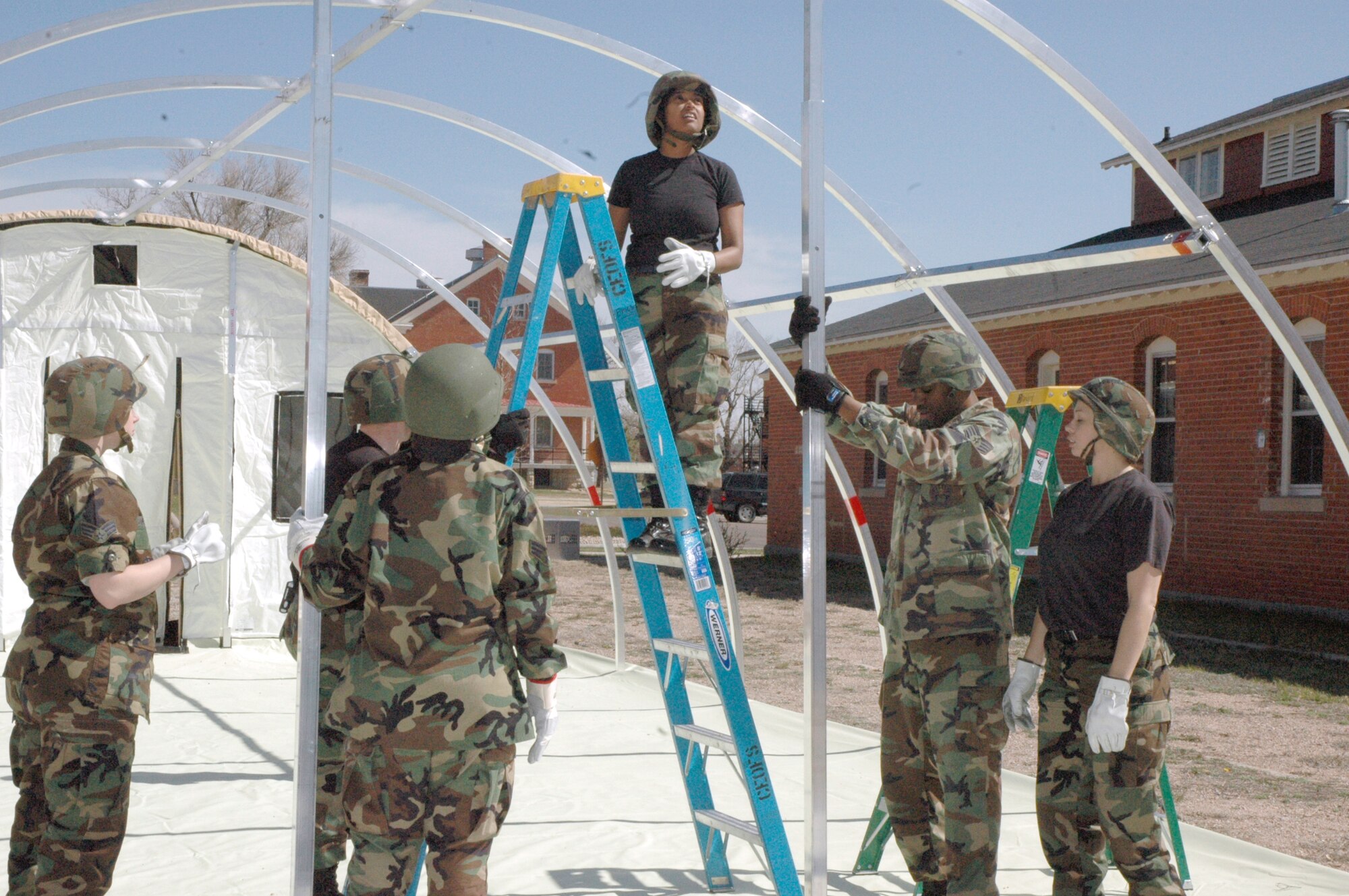 Members of the 90th Services Squadron participate in home–station training, a required yearly training, Friday. The training involved erecting tents, setting up equipment within the tents to prepare food and practicing performing duties in real-world situations (Photo by Airman Alex Martinez).