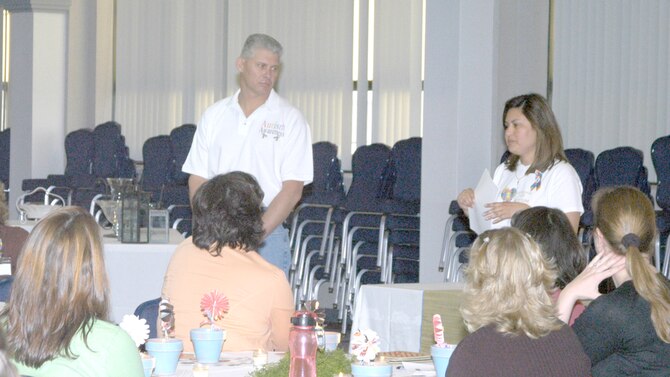 Leanna Perez-Green, right, wife of Chief Master Sergeant David Green, 90th Space Wing command chief, speaks to about 70 members of the Warren Spouses Club about National Autism Awareness Month in the Pronghorn Center April 17. Their son, Levi, was diagnosed with autism when he was 4 years old (Photo by Capt. Nora Eyle).