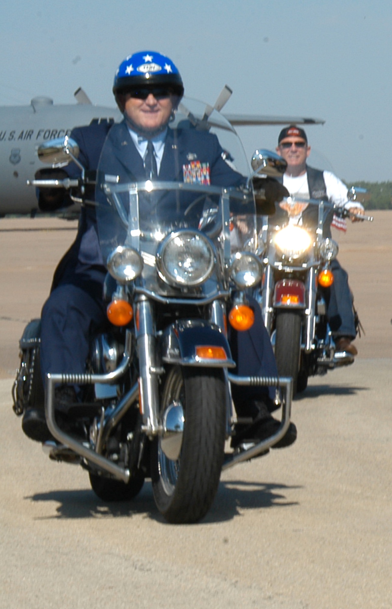 Chief Master Sgt. Paul Wheeler, 7th Bomb Wing command chief, rides his Harley-Davidson motorcycle at the Harley Owners Group (HOG) rally on the flightline May 2006. Even in his full service dress uniform, Chief Wheeler practices safety precautions (helmet, gloves, glasses and boots) to ensure he and thousands of other HOG riders are safe. (U.S. Air Force photo by Airman 1st Class Carolyn Viss)