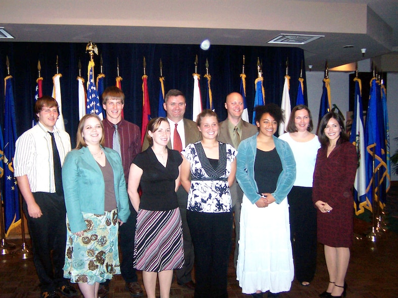 The Officers Spouses and Enlisted Spouses clubs awarded more than $13,000 in scholarships to students April 19. Front row: Angela Minear OSC co-chair, Erin Bailey, Kelsey Ashmore, Iris Grooms and Christine Caldwell. Back row: Eli Godwin, Jayme Nauman, Col. Scott West, 27th Fighter Wing commander, Chief Master Sgt. Allen Millinac, 27th Aircraft Maintenance Squadron, and Bonnie Gillespie. (Courtesy photo) 