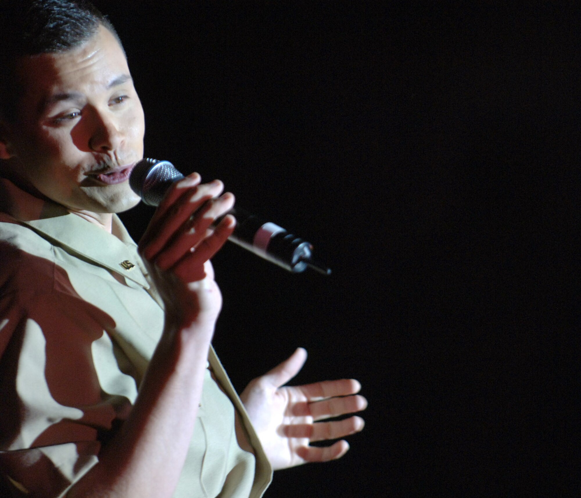 Staff Sgt. Daniel Rutherford croons before servicemembers during a Tops In Blue performance April 28 at Balad Air Base, Iraq. Thirty eight active-duty Airmen with the Air Force's premier expeditionary entertainers set out in mid-April to kick off their 2007 tour singing and dancing their way through the area of responsibility. They will tour Southwest Asia for three weeks, and continue their 2007 tour through February 2008. Sergeant Rutherford is a cryptologic linguist with the 22nd Intelligence Squadron at Fort Meade, Md. (U.S. Air Force photo/Staff Sgt. Michael R. Holzworth) 

