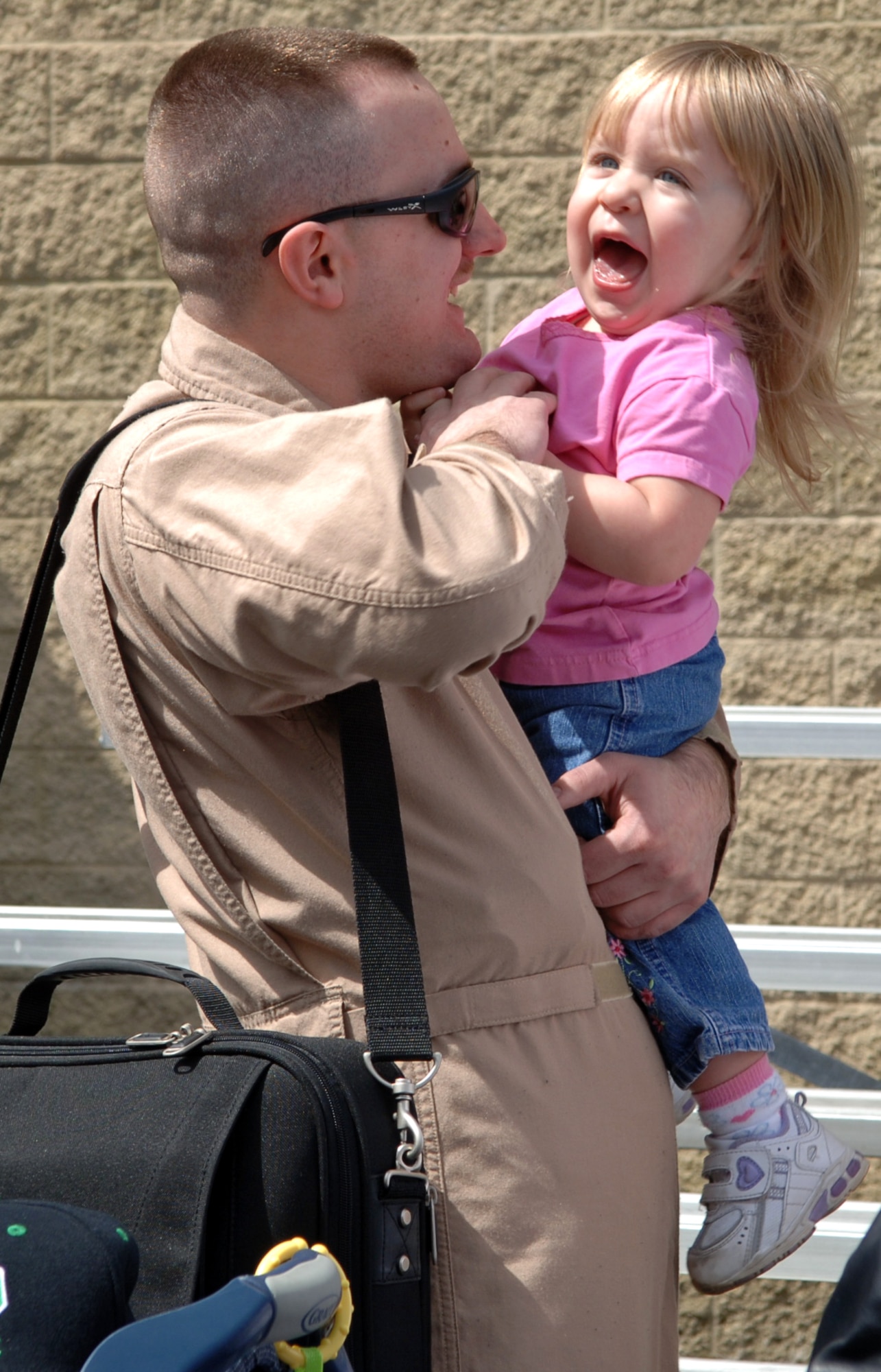 FAIRCHILD AIR FORCE BASE, Wash. – Staff Sgt. Michael Overman tickles his two and a half year old daughter, Miquela, just minutes after disembarking a KC-135. Sergeant Overman returned with approximately 40 other deployers from Manas Air Base, Kyrgyzstan. (U.S. Air Force Photo/Airman 1st Class Jocelyn Ford)
