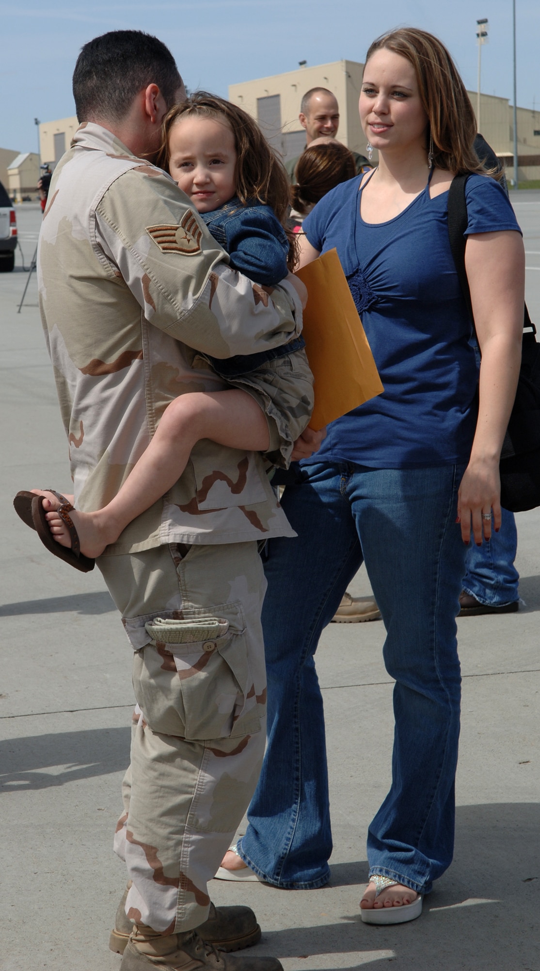 FAIRCHILD AIR FORCE BASE, Wash. -- Jasmine Hernandez receives a big hug from her father, Tech. Sgt. Juan Hernandez, just minutes after his return on April 30. Sergeant Hernandez returned with approximately 40 other deployers from Manas Air Base, Kyrgyzstan. (U.S. Air Force Photo/Airman 1st Class Jocelyn Ford)
