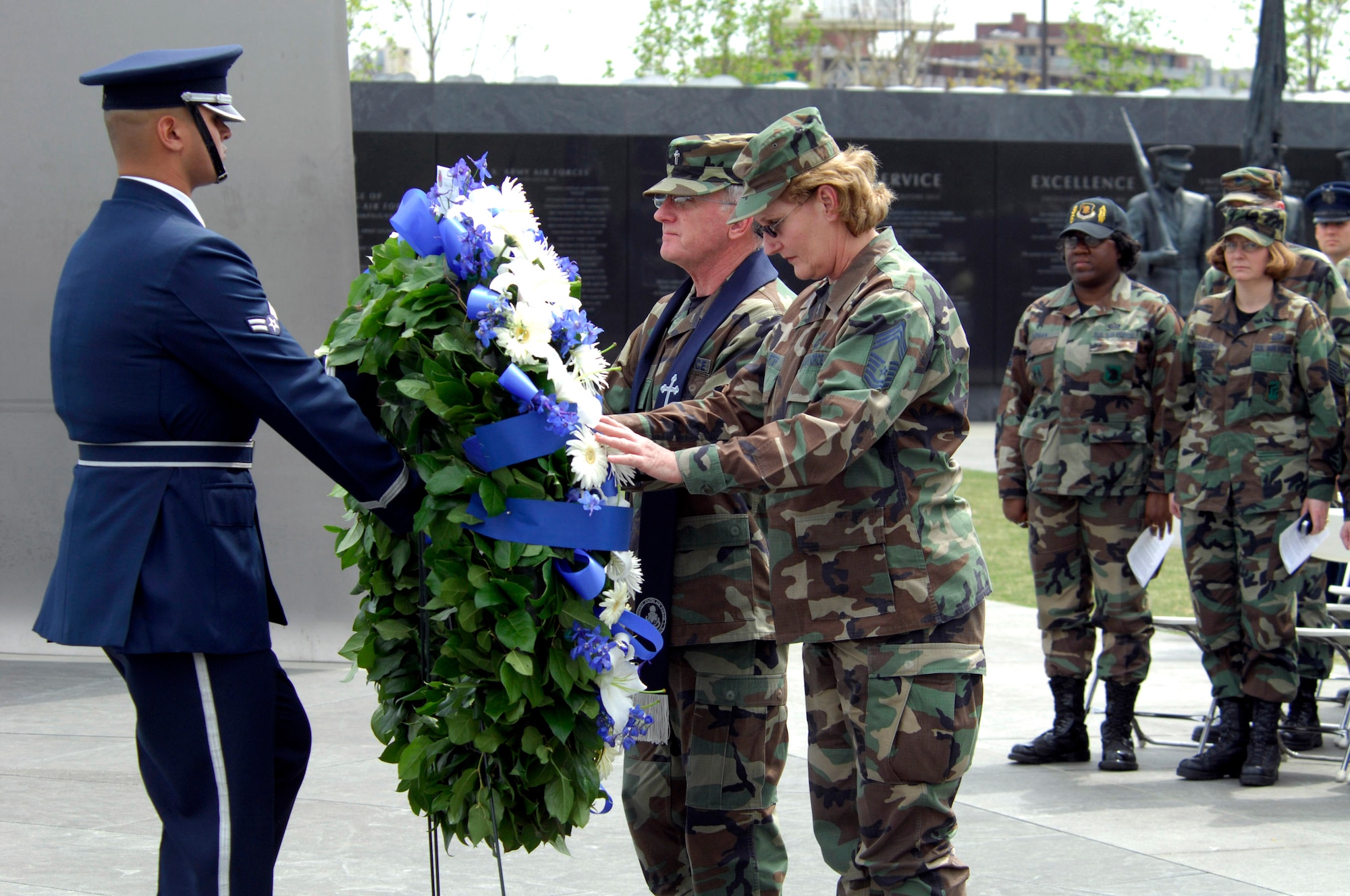 Chaplain (Maj. Gen.) Charles Baldwin and Chief Master Sergeant Kaye Carter place a ceremonial wreath in position at the base of the Air Force Memorial April 25 with the help of Airman 1st Class Kirk Campbell of the Air Force Honor Guard.  General Baldwin is chief of Air Force chaplains and Chief Carter is the chaplain's assistant career field manager. (U.S. Air Force photo/Tech. Sgt. Cohen A. Young) 