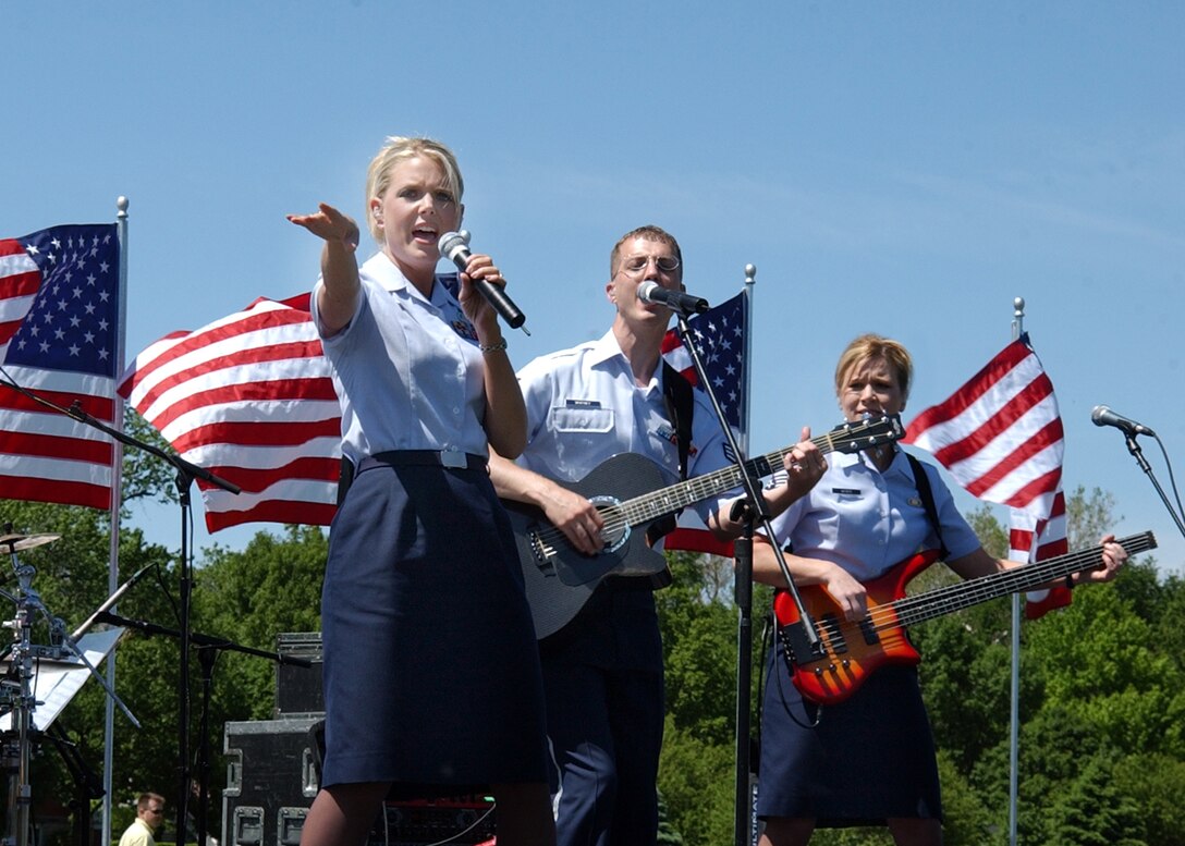 OFFUTT AFB NE - SrA Lara Murdzia, SrA Clint Whitney and TSgt Lori Weber wow the audience on Offutt's parade field during one of the band's "Sundays on Parade" series concerts.