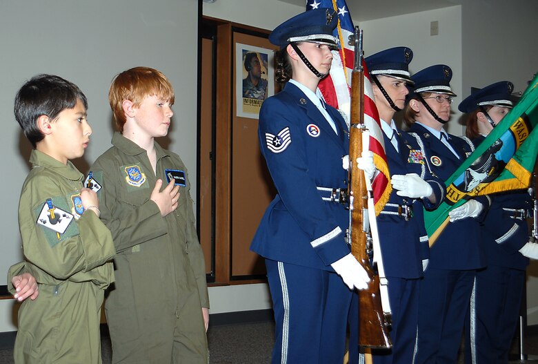 FAIRCHILD AIR FORCE BASE, Wash. -- Kevin Tsuchinda and Cameron Campbell recite the pledge of allegiance while accompanied by the 141st Air Refueling Wing’s honor guard April 18. These two boys were treated to an orientation through the 141st ARW’s Pilot for a day Program. (U.S. Air Force photo/Senior Master Sgt. Bob Thackston)