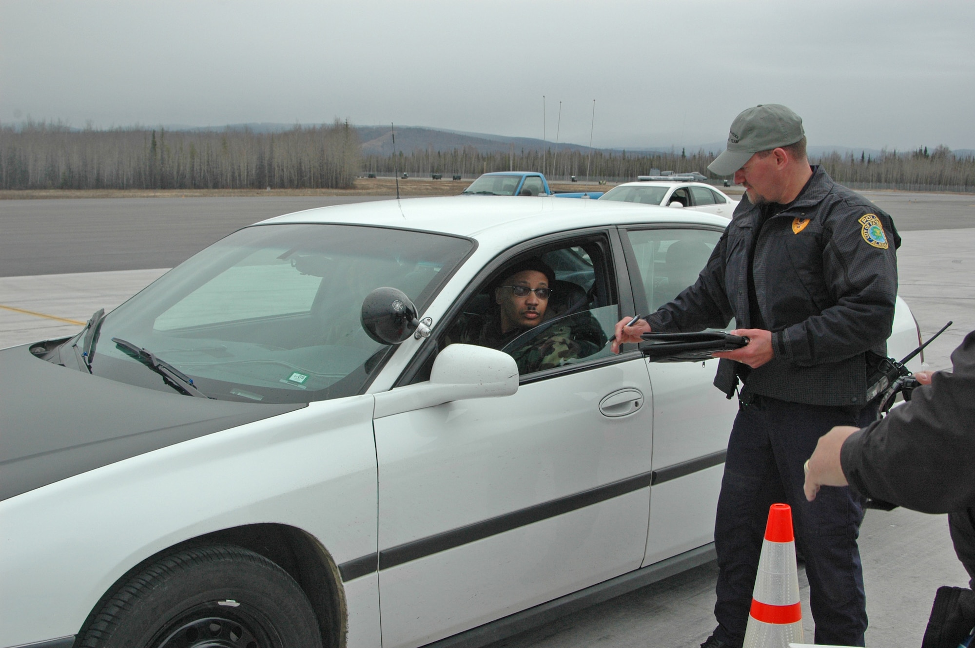 EIELSON AIR FORCE BASE, Alaska--Officer Jeromey Lindhag, Fairbanks Police Department evasive vehicle operations course instructor, gives a Master Sgt. William Brown, 354th Operations Support Squadron, the go-ahead for the course April 27 on the Sierra Loop of the flightline here. The EVOC was set up for local law enforcement agencies to have a first-ever joint training exercise. (U.S. Air Force Photo by Airman 1st Class Nora Anton)