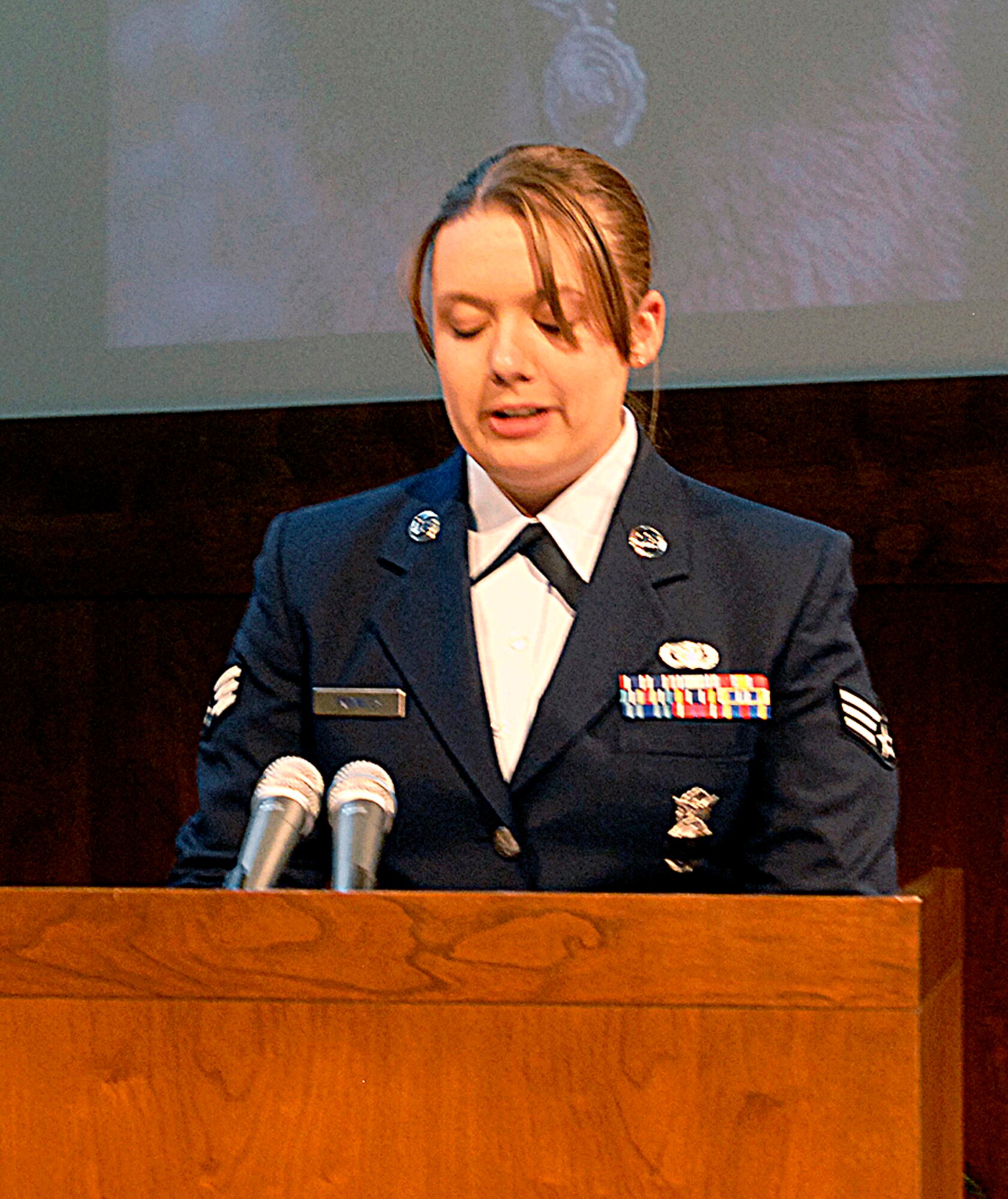 BUCKLEY AIR FORCE BASE, Colo. -- Senior Airman Tasia Trombley, 460th Security Forces Squadron military working dog handler, speaks at the memorial for Dac, her military working dog for about a year, April 27 at the Base Chapel. Dac was put to sleep Feb. 24 at the Fort Carson Veterinary Clinic due to a deteriorating medical condition. About 75 people attended the ceremony, including memebers of the Aurora and Denver police departments, Department of Homeland Security, Peterson Air Force Base, the U.S. Air Force Academy and Fort Carson. Dac, a German Shephard, was accepted into the K-9 program June 13, 2000, and served here from April 2001 until his passing. (U.S. Air Force photo by Senior Airman Logan Tuttle)