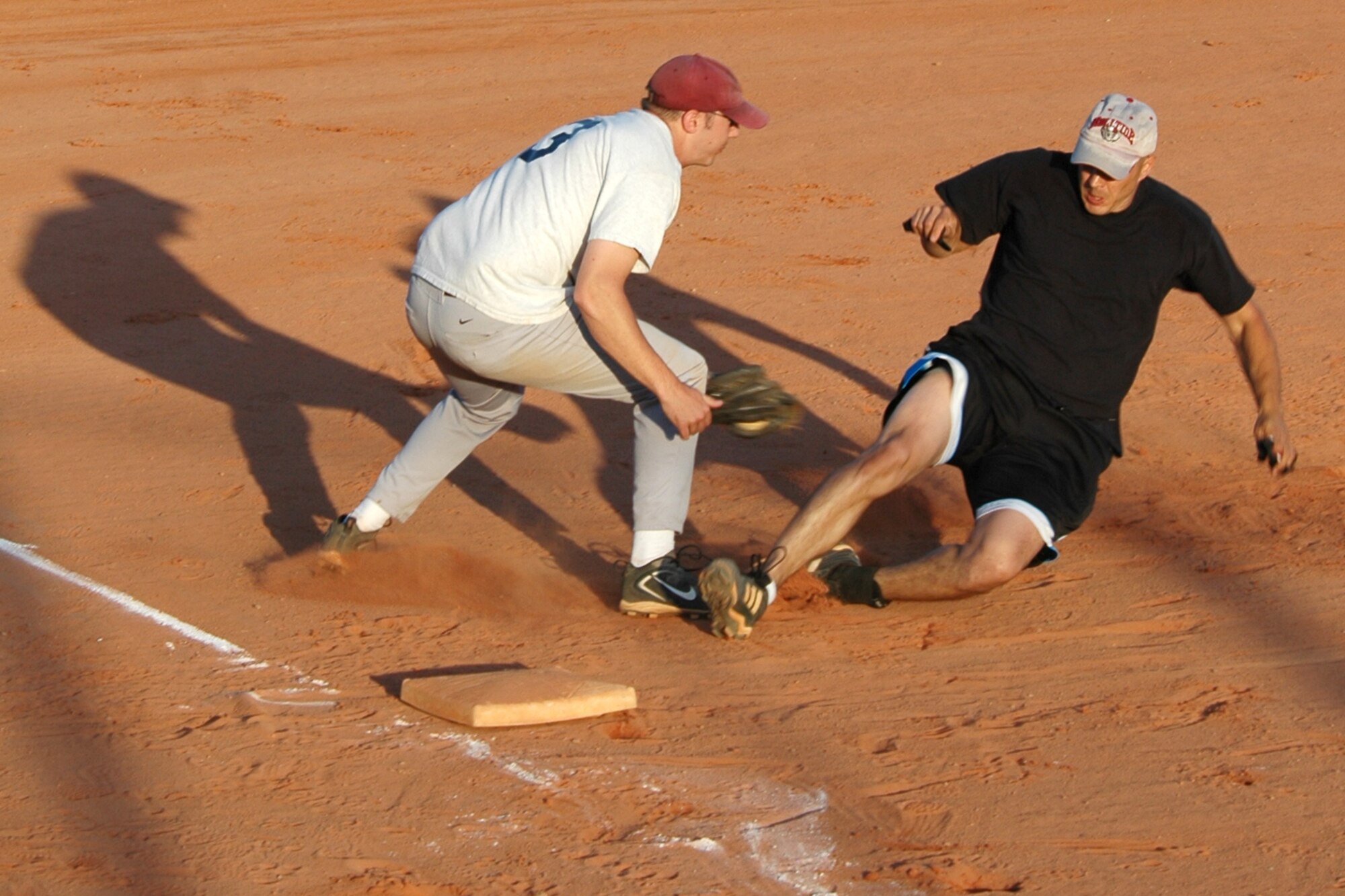 EGLIN AIR FORCE BASE, Fla. -- Greg Burg, 53rd Wing third baseman, lays the tag on Tim Sandlin, 96th Logistics Readiness Squadron, in a close play at third base April 30 during the 2007 intramural softball season opening day. Sandlin was called safe on the play. The 96th LRS team edged out 53rd Wing 12-9 in their opener. The intramural league consists of 26 teams spread among two leagues. Each team will play 12 games throughout the season to earn a position in the postseason playoffs scheduled for later this summer. (U.S. Air Force photo by Staff Sgt. Mike Meares)