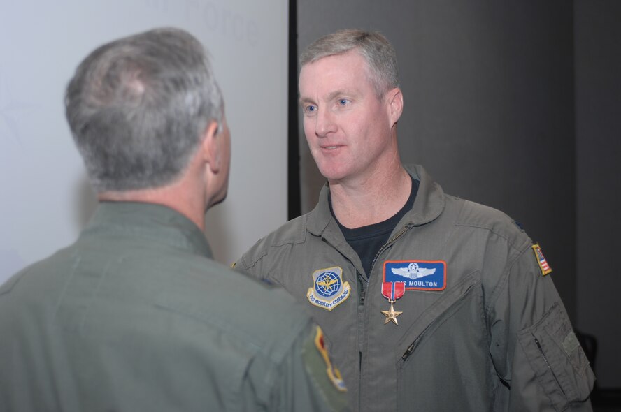 Colonel James Moulton, 317th Airlift Group deputy commander, is surprised to receive a Bronze Star Medal from Maj. Gen. James A. Hawkins, 18th Air Force commander, April 26 during a ceremony that included five other outstanding unit and personnel award presentations. (Photo by Airman Domonique Simmons)