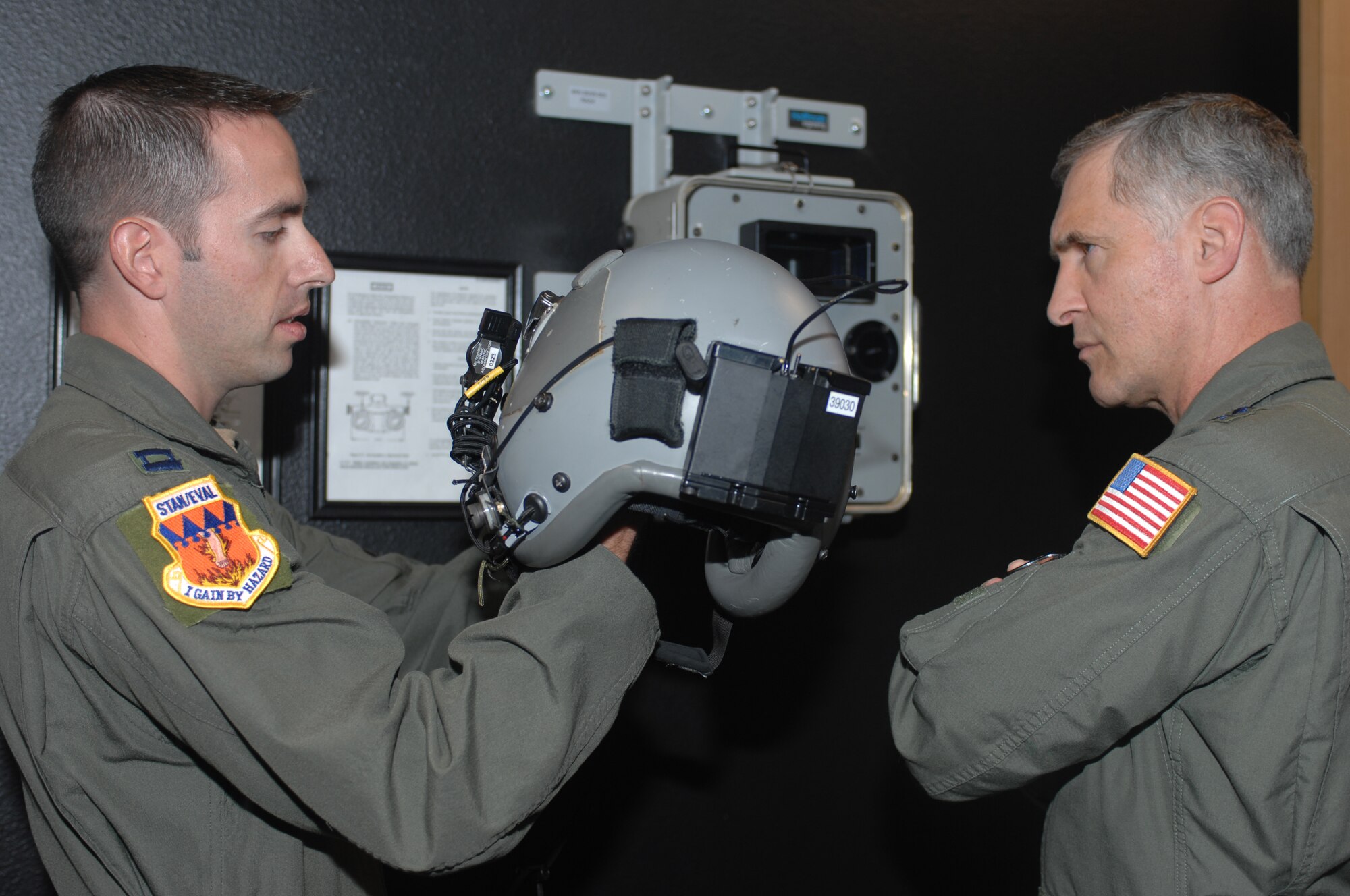 Capt. Ryan Consie, 317th Airlift Group, shows Maj. Gen. James A. Hawkins, 18th Air Force commander, the latest night vision goggles at the 317th AG life support office April 26. General Hawkins' visit included presenting members of the 317th AG with six awards and accolades. (U.S. Air Force photo by Airman Domonique Simmons)