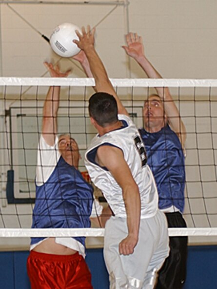 Jody Manuel (left) and Casey Fielder (right), 319th Logistics Readiness Squadron Team A, block a spike from LRS team B during the intramural volleyball playoffs April 25.  (U.S. Air Force photo/Airman 1st Class Ashley Coomes)
