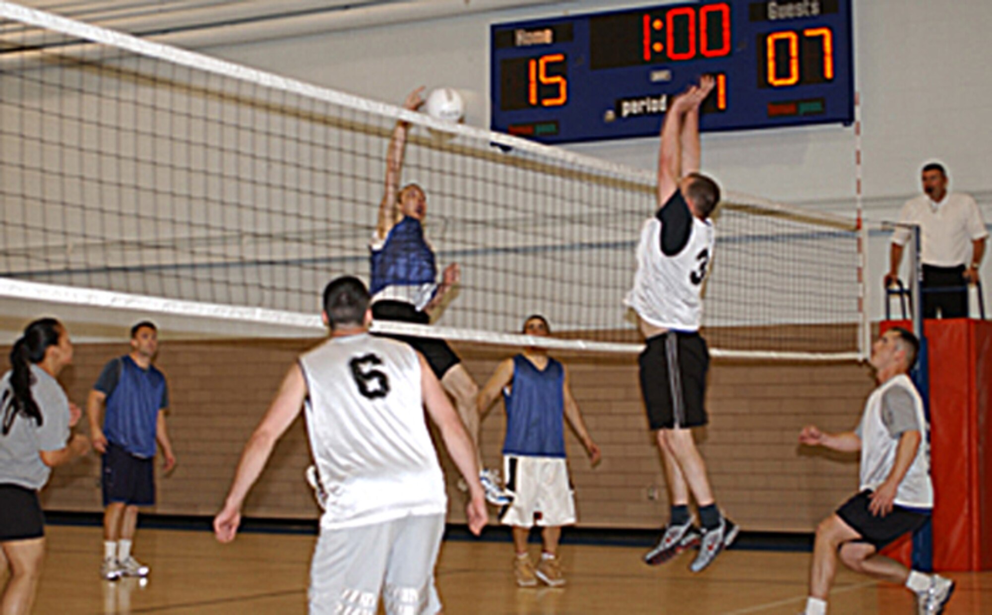 Casey Fielder, 319th Logistics Readiness Squadron Team A, slams the ball making a kill against LRS team B during the intramural volleyball playoffs April 25. LRS A continues to fight for the title of champion April 30, against the 319th Mission Support and Services Squadron. (U.S. Air Force photo/Airman 1st Class Ashley Coomes)