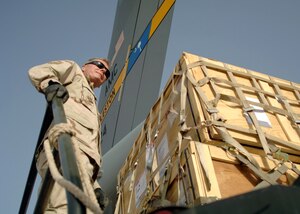Senior Master Sgt. Tom Luke coordinates the offload of a C-17 Globemaster III from Charleston Air Force Base, S.C., April 21 at at Al Asad Air Base, Iraq. Since January, Airmen assigned to the 438th Aerial Port Flight have processed more than 32,000 passengers, 15,528 tons of cargo and more than 2,600 aircraft keeping nearly 12,000 American servicemembers off the roads in convoys. Sergeant Luke is a day shift supervisor with the 438th APF. (U.S. Air Force photo/Capt. Ken Hall)
