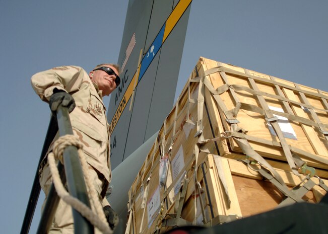 Senior Master Sgt. Tom Luke coordinates the offload of a C-17 Globemaster III from Charleston Air Force Base, S.C., April 21 at at Al Asad Air Base, Iraq. Since January, Airmen assigned to the 438th Aerial Port Flight have processed more than 32,000 passengers, 15,528 tons of cargo and more than 2,600 aircraft keeping nearly 12,000 American servicemembers off the roads in convoys. Sergeant Luke is a day shift supervisor with the 438th APF. (U.S. Air Force photo/Capt. Ken Hall)