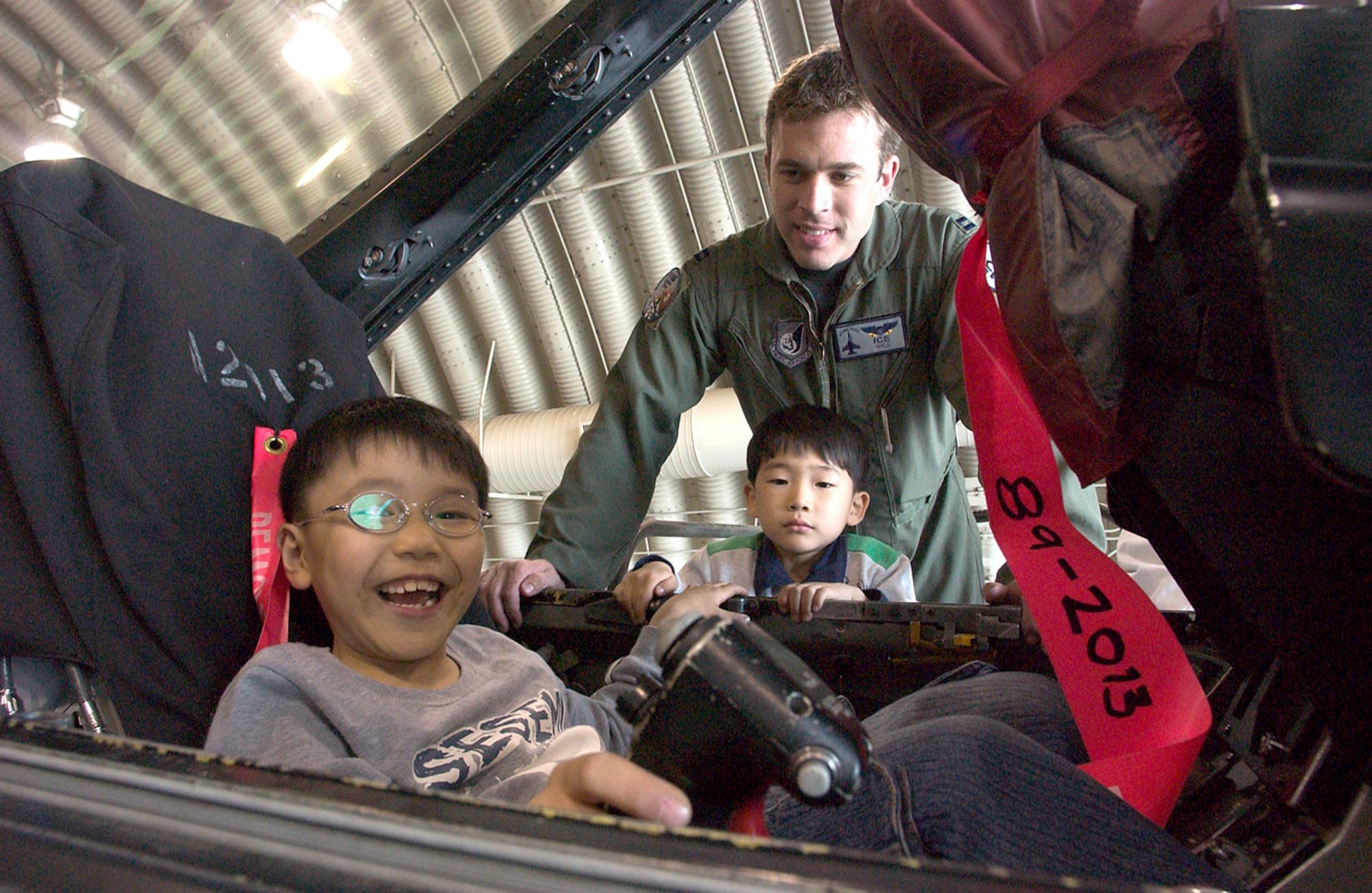 Capt. Aaron Jelinek shows an F-16 Fighting Falcon cockpit to children from a Gunsan City orphanage during their visit April 27 to Kunsan Air Base, South Korea. Airmen of the 35th Fighter Squadron hosted children from the orphanage as part of the 8th Fighter Wing's Good Neighbor Program. Captain Jelinek is a fighter pilot with the 35th FS. (U.S. Air Force photo/Senior Airman Barry Loo) 