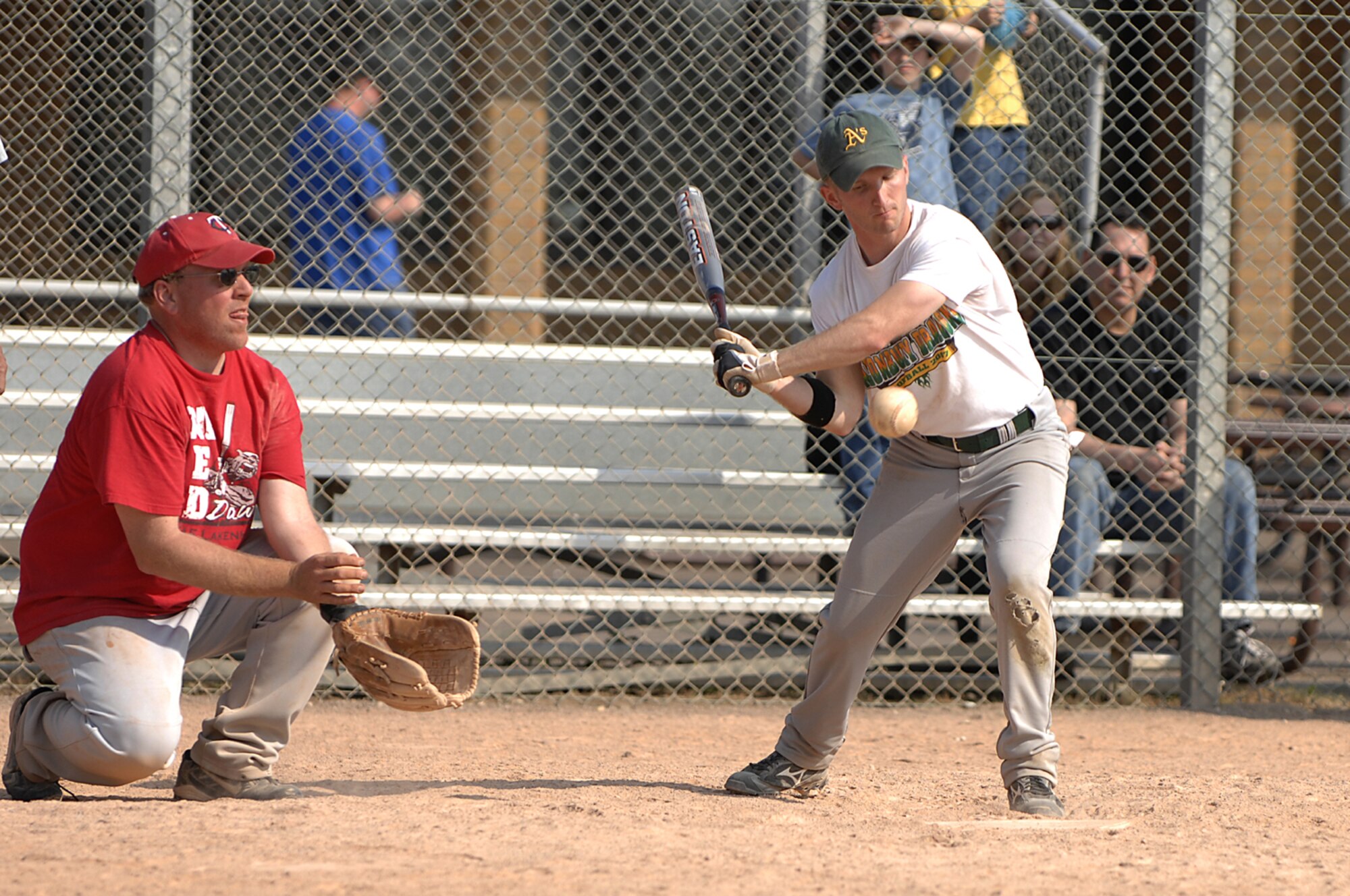 Mike Ott, RAF Alconbury softball team, looks to bring in some runs as Steve Larson, 48th Medical Group softball team, mans the back stop during the championship game of a Medical Group Top 3 softball tournament at RAF Lakenheath on April 29, 2007. The 48 Medical Group defeated RAF Alconbury in two straight games to win the double elimination tournament. (U.S. Air Force photo by SrA Brian J. Ellis)