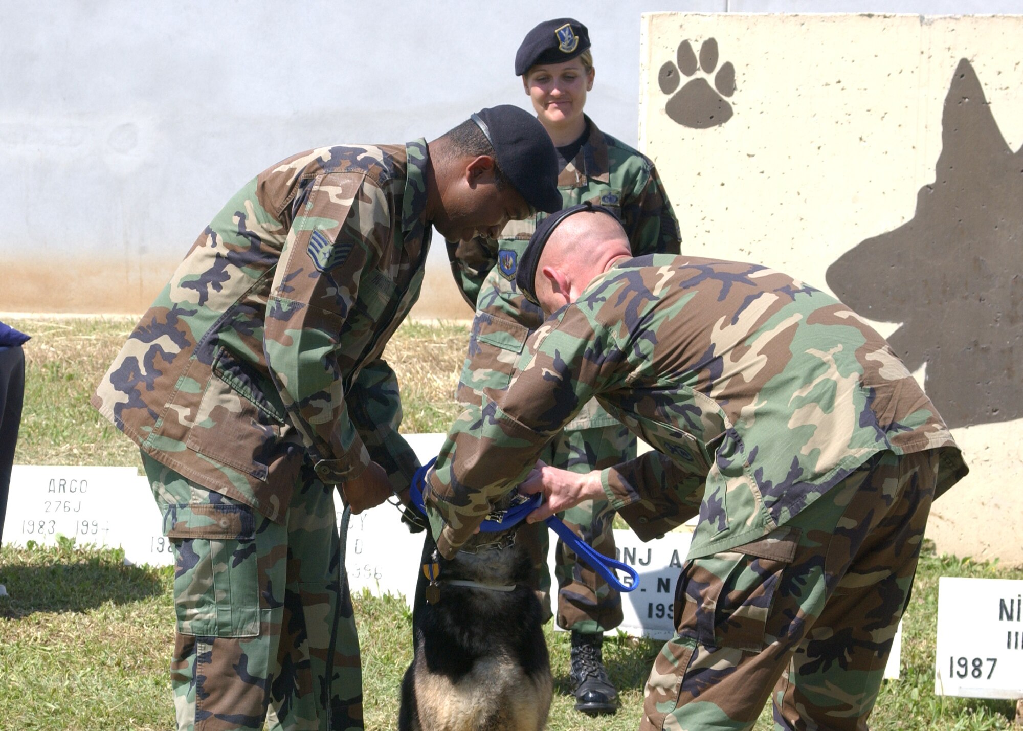 Col. "Tip" Stinnette, 39th Air Base Wing commander, and Staff Sgt. Kennith Houston, 39th Security Forces Squadron, present Brosky A014 with a cloth leash to replace the standard steel military working dog leash during his Retirement Ceremony on April 27. Brosky has been part of Team Incirlik for the past nine years as a patrol/explosive detection military working dog.  (U.S. Air Force photo by Airman 1st Class Tiffany Colburn)                                                            