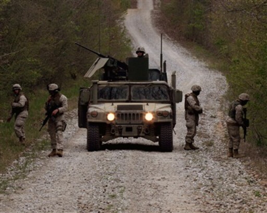 U.S. Marines and Navy sailors carefully comb the roadside for mock improvised explosive devices while training at Fort Pickett, Va., on April 18, 2007.  The Marines and sailors of Combat Logistics Battalion 22 are training to search for IEDs as they prepare to deploy as the ground combat element of the 22nd Marine Expeditionary Unit later this year.  