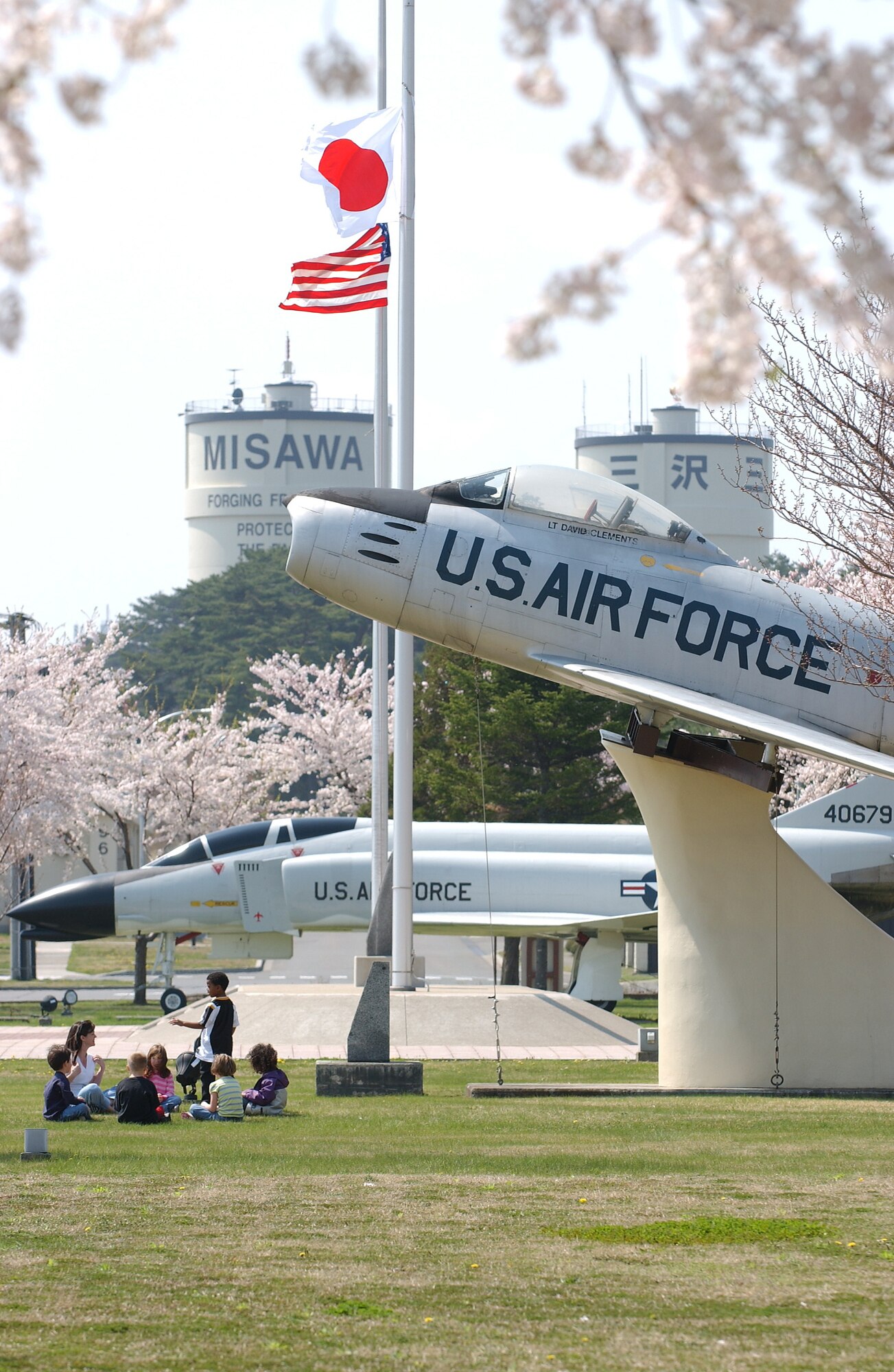 MISAWA AIR BASE, Japan -- Children play at Risner Circle on May 3, 2007.  Risner Circle, lined with Cherry Blossom trees, showcases a U.S. Air Force F-4 and F-86 jets, commemorating American and Japanese friendship. (U.S. Air Force photo by Airman 1st Class Benjamin Wilson)