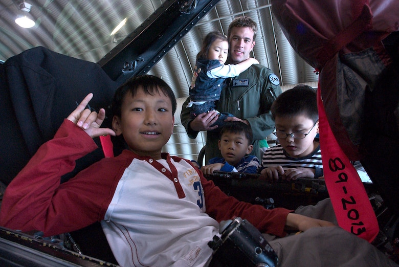 KUNSAN AIR BASE, Republic of Korea  April 27, 2007 -- Capt. Aaron Jelinek, 35th Fighter Squadron fighter pilot, shows an F-16 cockpit to children from a Gunsan City orphanage during their visit here April 27. The 35th FS hosted the orphanage as part of the 8th Fighter Wing's Good Neighbor Program commitment to supporting the community. The 35th, known as the "Pantons," is one of two F-16 Fighting Falcon squadrons assigned to the 8th Fighter Wing here. (U.S. Air Force photo/Senior Airman Barry Loo)