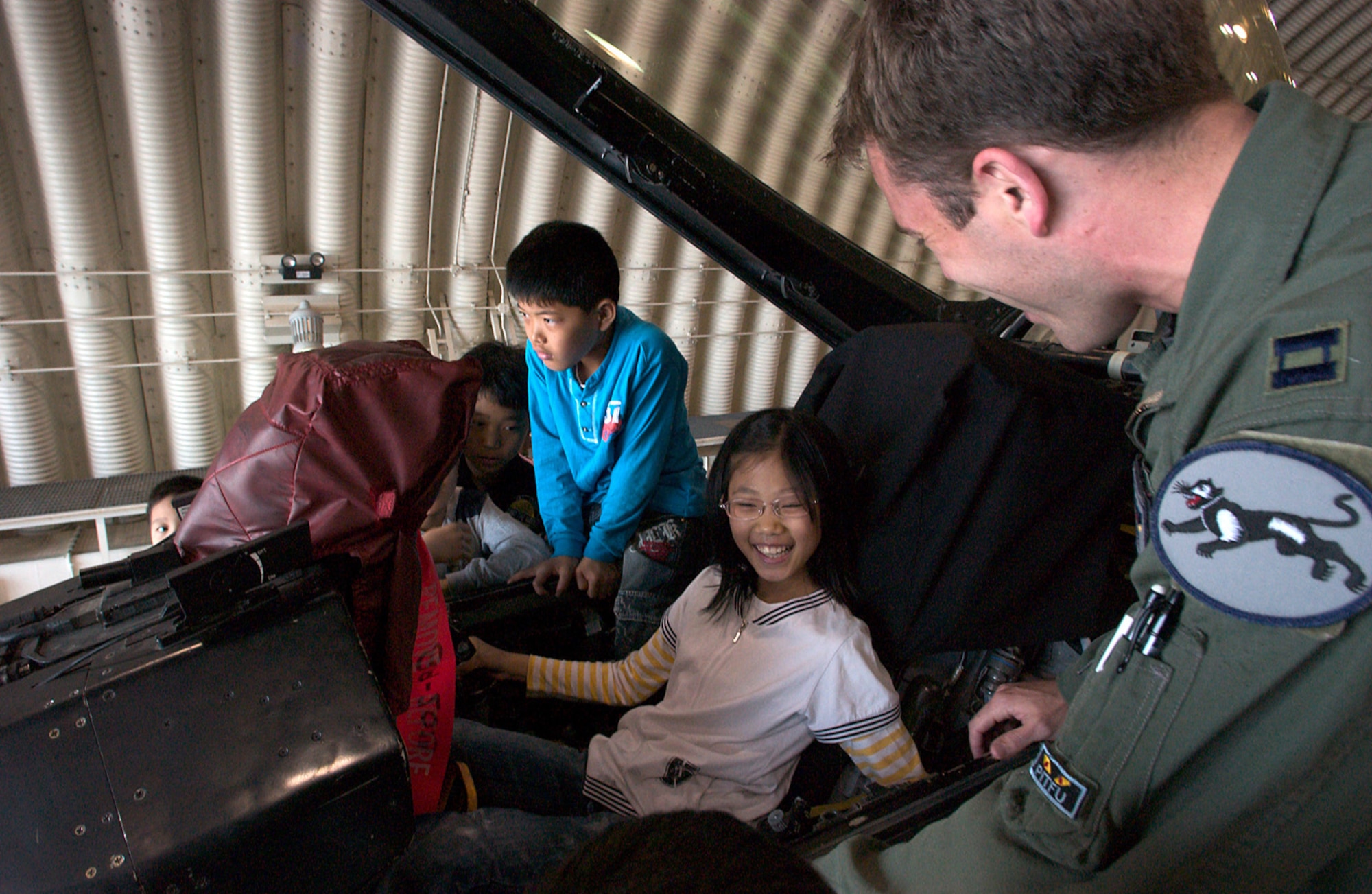 KUNSAN AIR BASE, Republic of Korea  April 27, 2007 -- Capt. Aaron Jelinek, 35th Fighter Squadron fighter pilot, shows off the inner workings of an F-16 cockpit to Gunsan City orphanage children during their visit here April 27. The 35th FS hosted the orphanage as part of the 8th Fighter Wing's Good Neighbor Program commitment to supporting the community. The 35th, known as the "Pantons," is one of two F-16 Fighting Falcon squadrons assigned to the 8th Fighter Wing here. (U.S. Air Force photo/Senior Airman Barry Loo)
