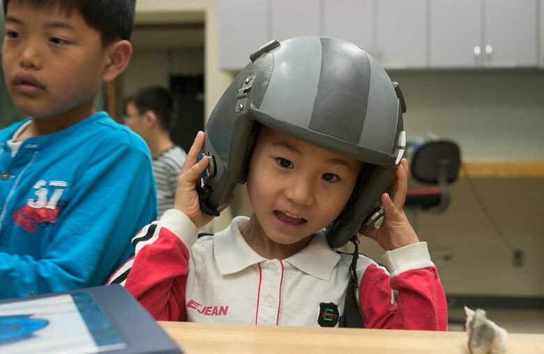 KUNSAN AIR BASE, Republic of Korea  April 27, 2007 -- A child from a local Gunsan City orphanage wears a fighter pilot helmet during a visit to the 35th Fighter Squadron here April 27. The 35th FS hosted the orphanage as part of the 8th Fighter Wing's Good Neighbor Program commitment to supporting the community. The 35th, known as the "Pantons," is one of two F-16 Fighting Falcon squadrons assigned to the 8th Fighter Wing here. (U.S. Air Force photo/Senior Airman Barry Loo)