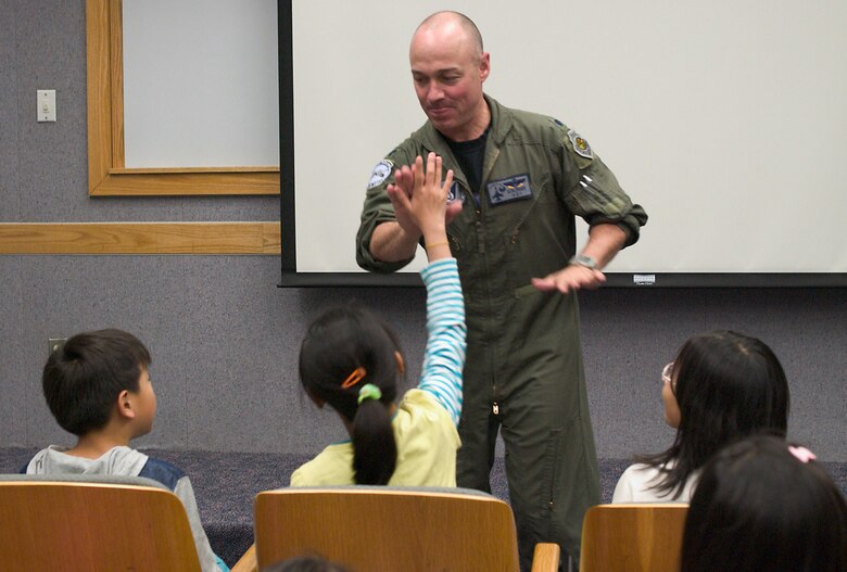 KUNSAN AIR BASE, Republic of Korea  April 27, 2007 -- Lt. Col. Scott Long, 35th Fighter Squadron commander, gives a high five to visiting Gunsan City orphanage children April 27. The 35th FS hosted the orphanage as part of the 8th Fighter Wing's Good Neighbor Program commitment to supporting the community. The 35th, known as the "Pantons," is one of two F-16 Fighting Falcon squadrons assigned to the 8th Fighter Wing here. (U.S. Air Force photo/Senior Airman Barry Loo)