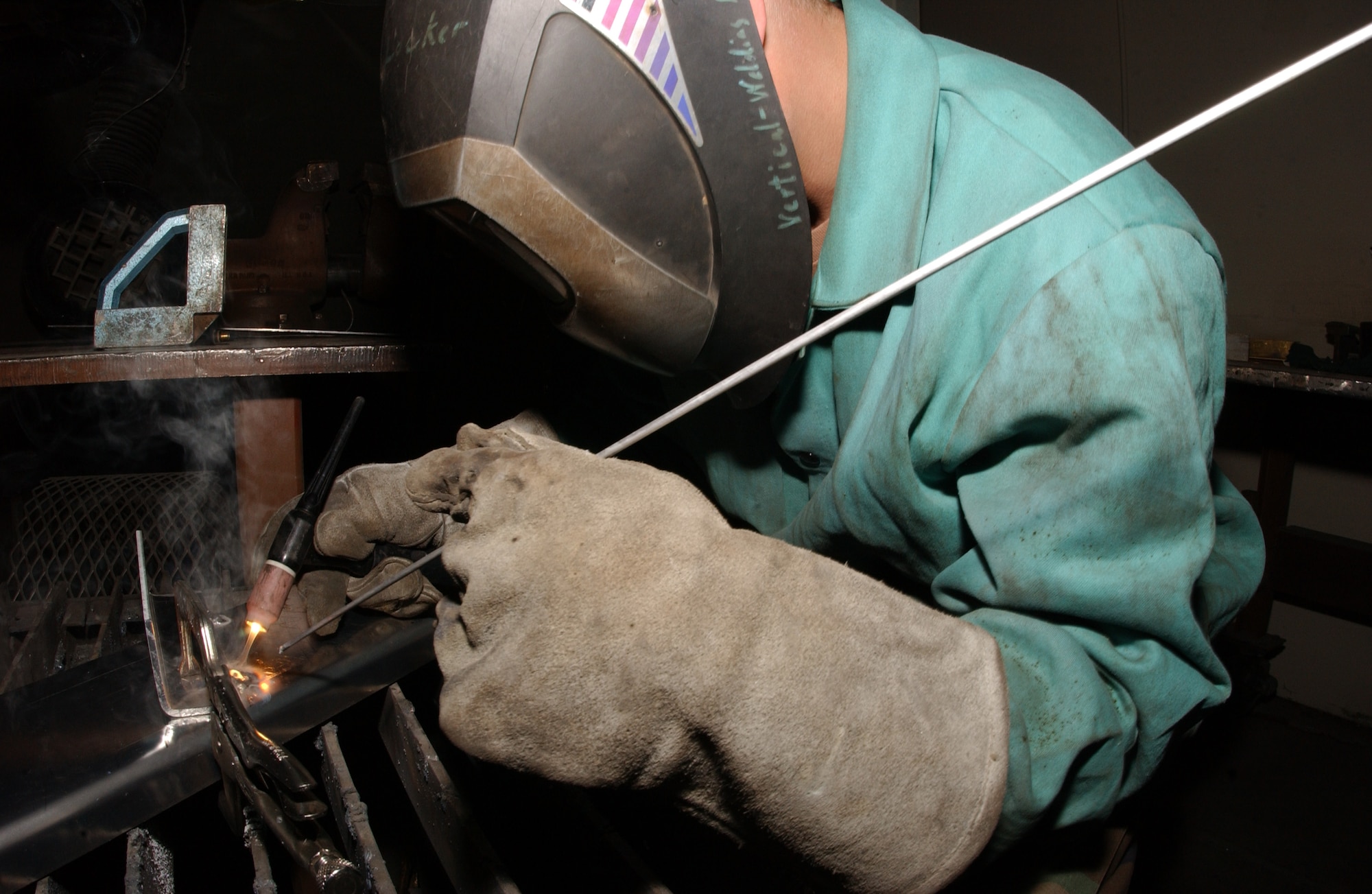 EIELSON AIR FORCE BASE, Alaska -- Senior Airman Joe Hensley, 354th Civil Engineer Squadron, uses a Tungsten Inert Gas (TIG) welder fusing two aluminum metals together on May 01. Airman Hensley is working on the stairs section of a halfpipe for the youth center in efforts to improve quality of life on base. (U.S. Air Force photo by Airman 1st Class Jonathan Snyder) 