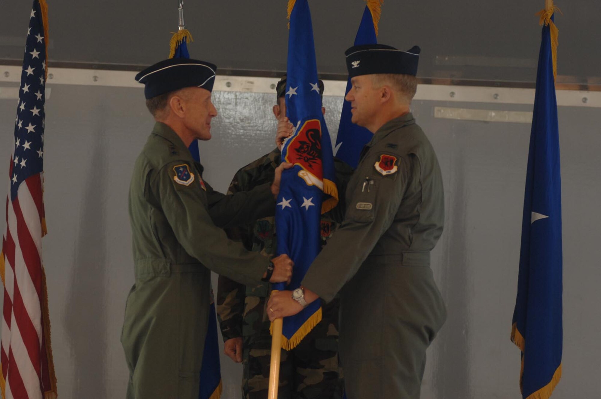 Lt. Gen. Norman Seip, 12th Air Force commander, hands the 432nd Wing flag to Col. Christopher Chambliss, the first commander of the newly reactivated 432nd Wing, during a ceremony at Creech Air Base. (U.S. Air Force photo/Airman 1st Class Nadine Barclay)