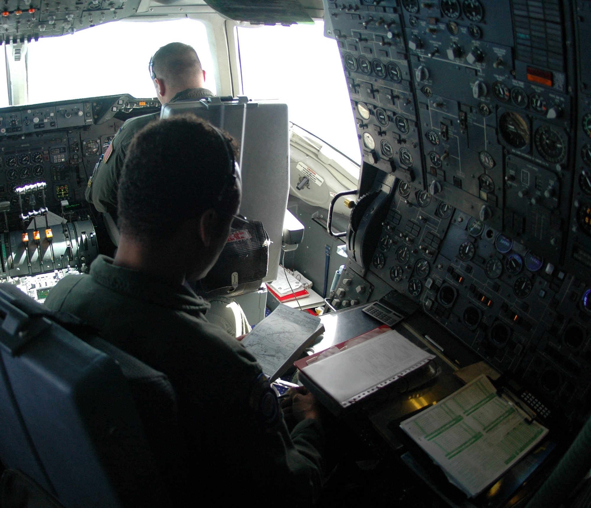 Staff Sgt. Talbert Reese, 9th Air Refueling Squadron flight engineer, checks controls on a KC-10 Extender during a refueling flight April 26. (U.S. Air Force photo by Tech. Sgt. Donald Osborn)