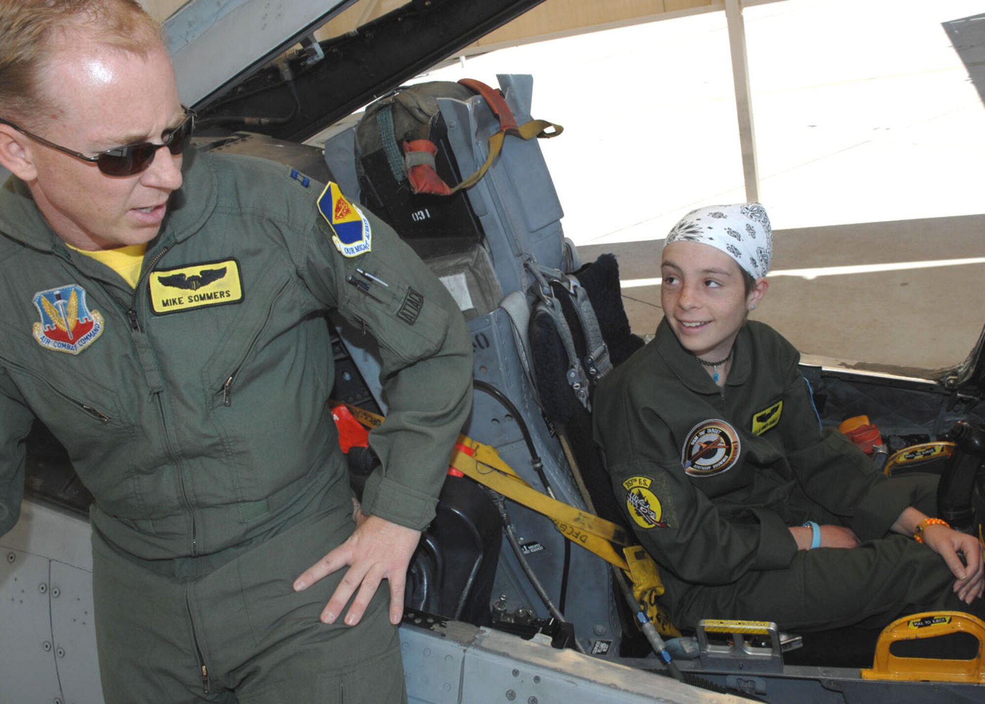Capt. Michael Sommers, an A-10 pilot with the 357th Fighter Squadron, teaches Kellie Miner-Durkit about the A-10 Thunderbolt II aircraft. The 13-year-old Miner-Durkit, a leukemia patient, was D-M's honorary pilot April 27 as part of the Pilot for a Day program.