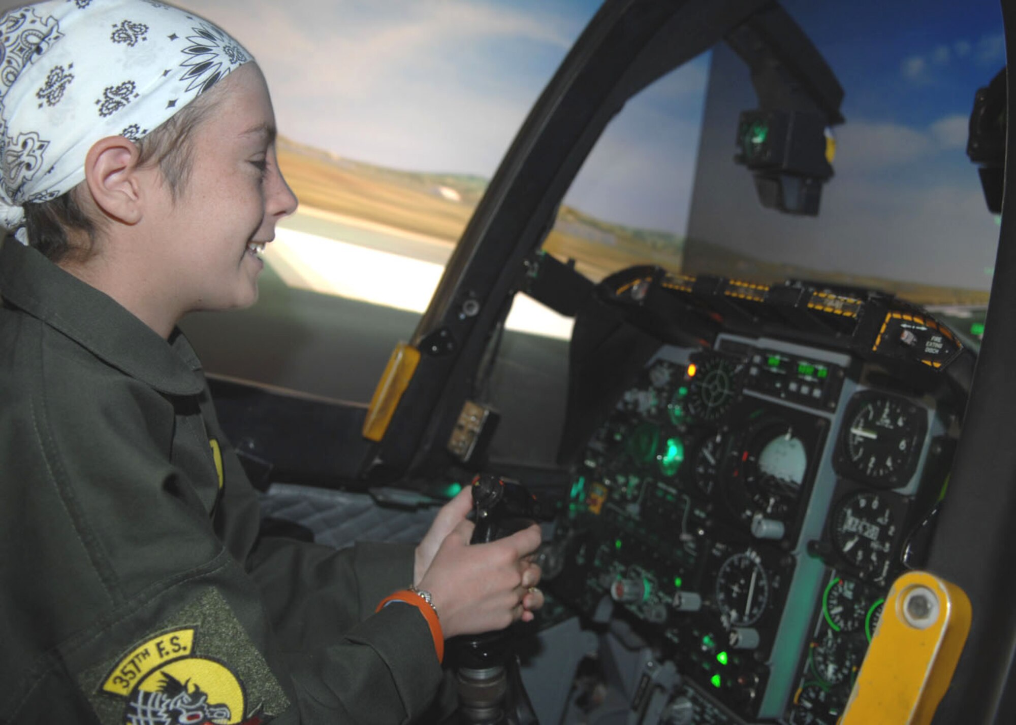 Kellie Miner-Durkit, 13, flies in an A-10 simulator at the 355th Operations Support Squadron. The simulator was one of several stops Miner-Durkit, a leukemia patient, made while visiting D-M April 27 as part of the Pilot for a Day program. 
