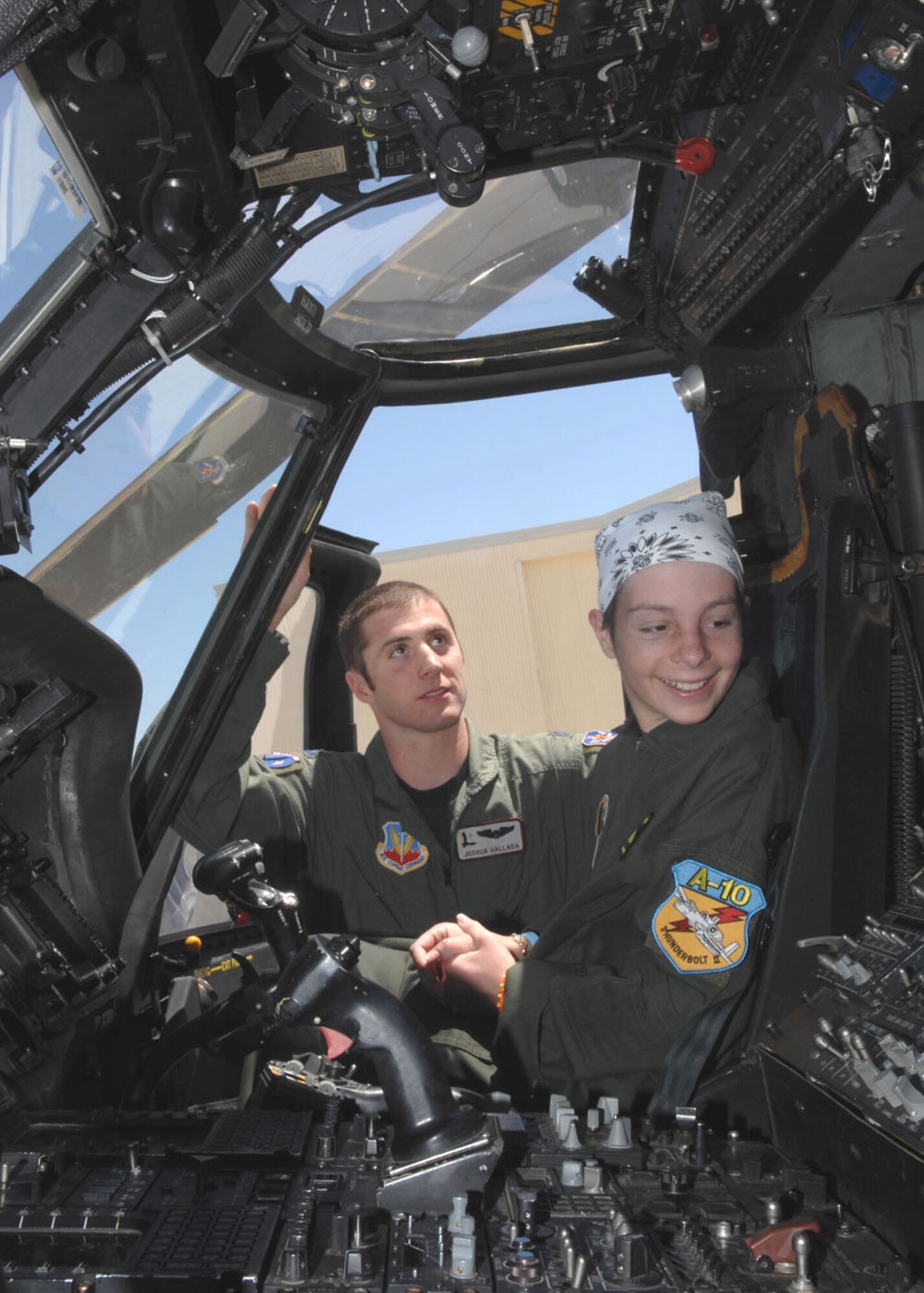 Thirteen-year-old Kellie Miner-Durkit sits in the pilot's seat of an HH-60 Pave Hawk helicopter, while Capt. Joshua Hallada, a pilot for the 55th Rescue Squadron here, explains the controls. The 55th RQS was one of several stops Miner-Durkit, a leukemia patient, made while visiting D-M April 27 as part of the Pilot for a Day program. 