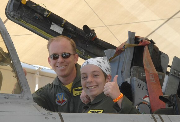 Capt. Michael Sommers, a pilot for the 357th Fighter Squadron here, and 13-year-old Kellie Miner-Durkit, Davis-Monthan's honorary Pilot for a Day, sit together in the cockpit of an A-10 Thunderbolt II aircraft.  The Pilot for a Day program is designed to find children with serious illnesses and help them enjoy a day totally devoted to them and their interest in aviation. 