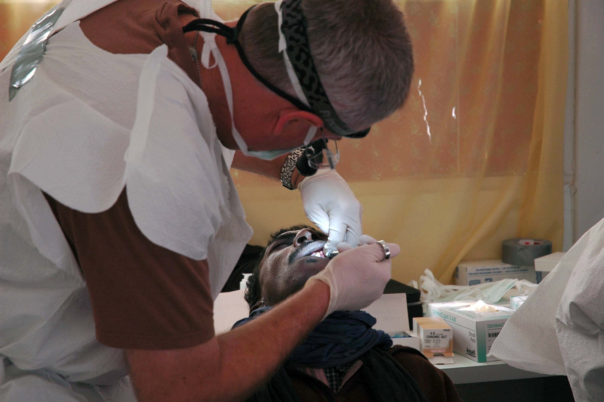 Maj. Brent Dupper, 452nd Aerospace Medicine Squadron dentist, prepares to extract a tooth of a Moroccan man at the village of Bouizakarne. Major Dupper is from March Air Force Base, Calif., and is participating in exercise African Lion. (U.S. Air Force photo/Tech. Sgt. Susan Stout)