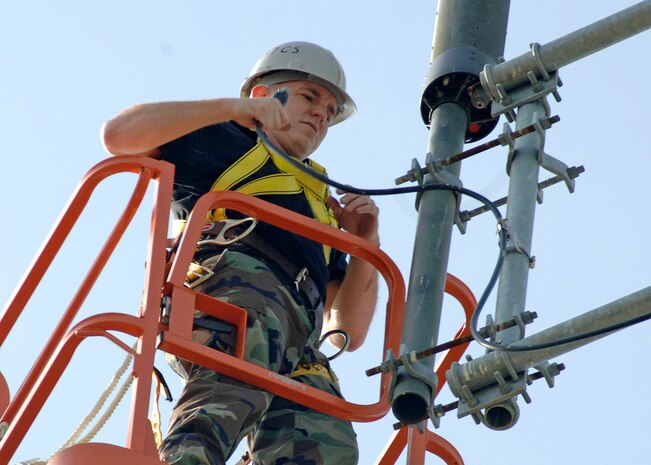 Staff Sgt. William Hoover, NCOIC of ground radio communications, replaces old ultra high frequency antenna with new antenna on the powered down tower, this allows command post to communicate with in and out bound aircrafts. (U.S. Air Force photo/Staff Sgt. April Quintanilla)