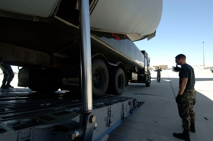 Charleston AFB loadmasters train augmentee loadmasters on how to properly secure a vehicle after it has been loaded on a C-17 April 28 at Davis-Monthan AFB, Ariz.(U.S. Air Force photo/Staff Sgt. April Quintanilla)