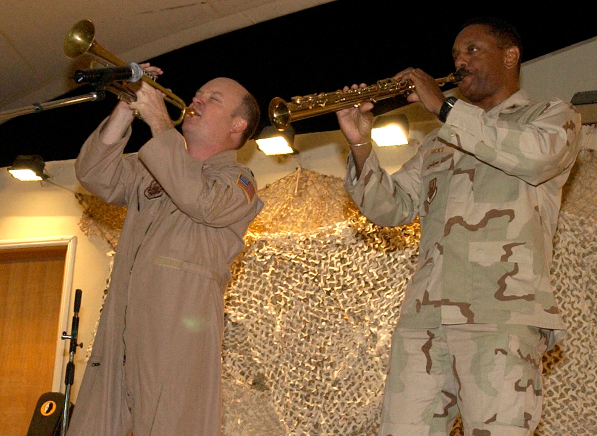 Lt. Col. Brian Reno, on trumpet, duos with Col. Otis Hicks on soprano saxophone, during a talent show at a deployed location in Southwest Asia. They played Led Zeppelin's 'Stairway to Heaven' classic. Colonel Reno is the chief of mobility operations for the Combined Air Operation Center and Colonel Hicks is the civil engineer director. (U.S. Air Force photo/Staff Sgt. Matthew McGovern)
