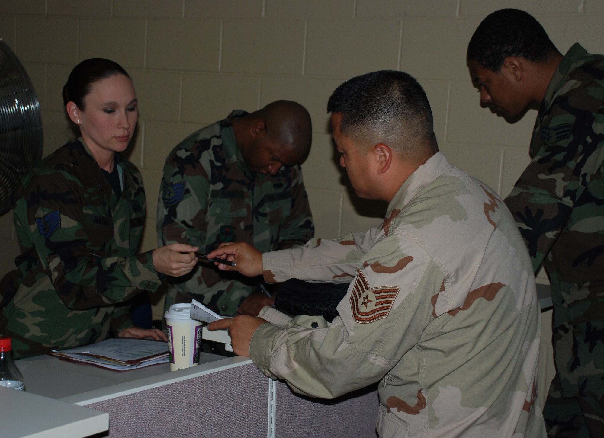Staff Sgt. Kerry Naylor, 82nd Military Personnel Flight, assits Tech Sgt. Aaron Wright, 82nd Medical Group main pharmacy as Sergeant Wright moves through the mobility line May 2. Team Sheppard is preparing to deploy over 100 Airmen to locations around the globe in support of the global war on terrorism. (U.S. Air Force photo/Airman 1st Class Jacob Corbin)