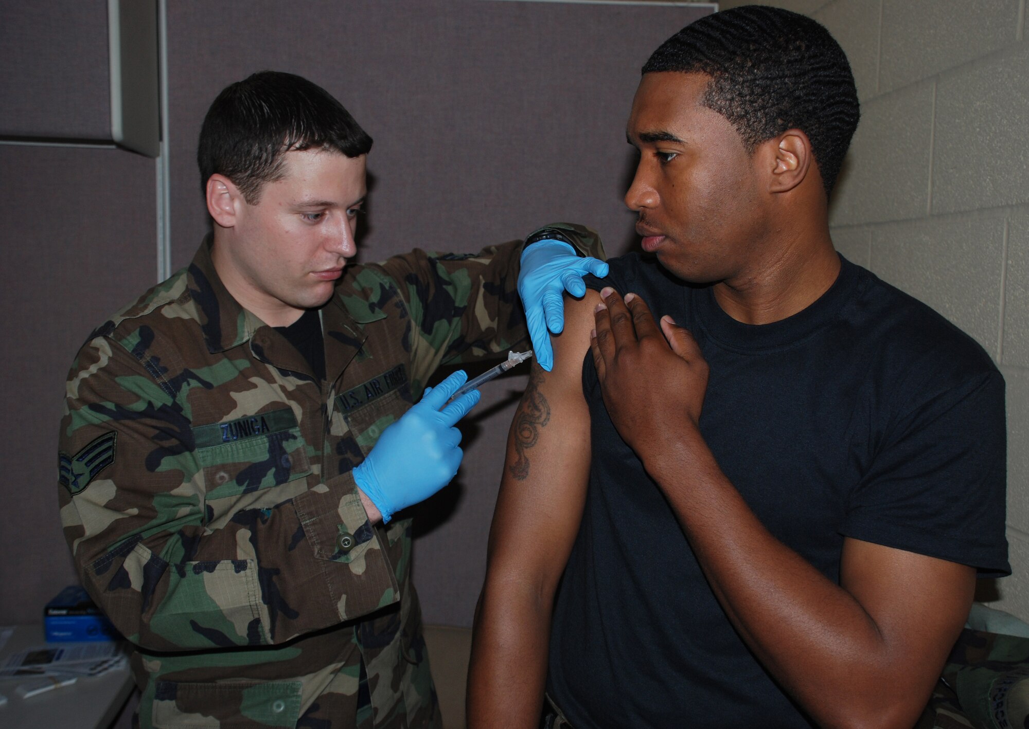 Staff Sgt. Jason Jones, 82nd Civil Engineering Squadron, recieves the last part of his anthrax vaccine from Senior Airman Robert Zuniga, 82nd Medical Group allergies and immunizations. Sergeant Jones recieved the shot while processing through the mobility line May 2. Team Sheppard is preparing to deploy over 100 Airmen to locations around the globe in support of the global war on terrorism. (U.S. Air Force photo/Airman 1st Class Jacob Corbin)