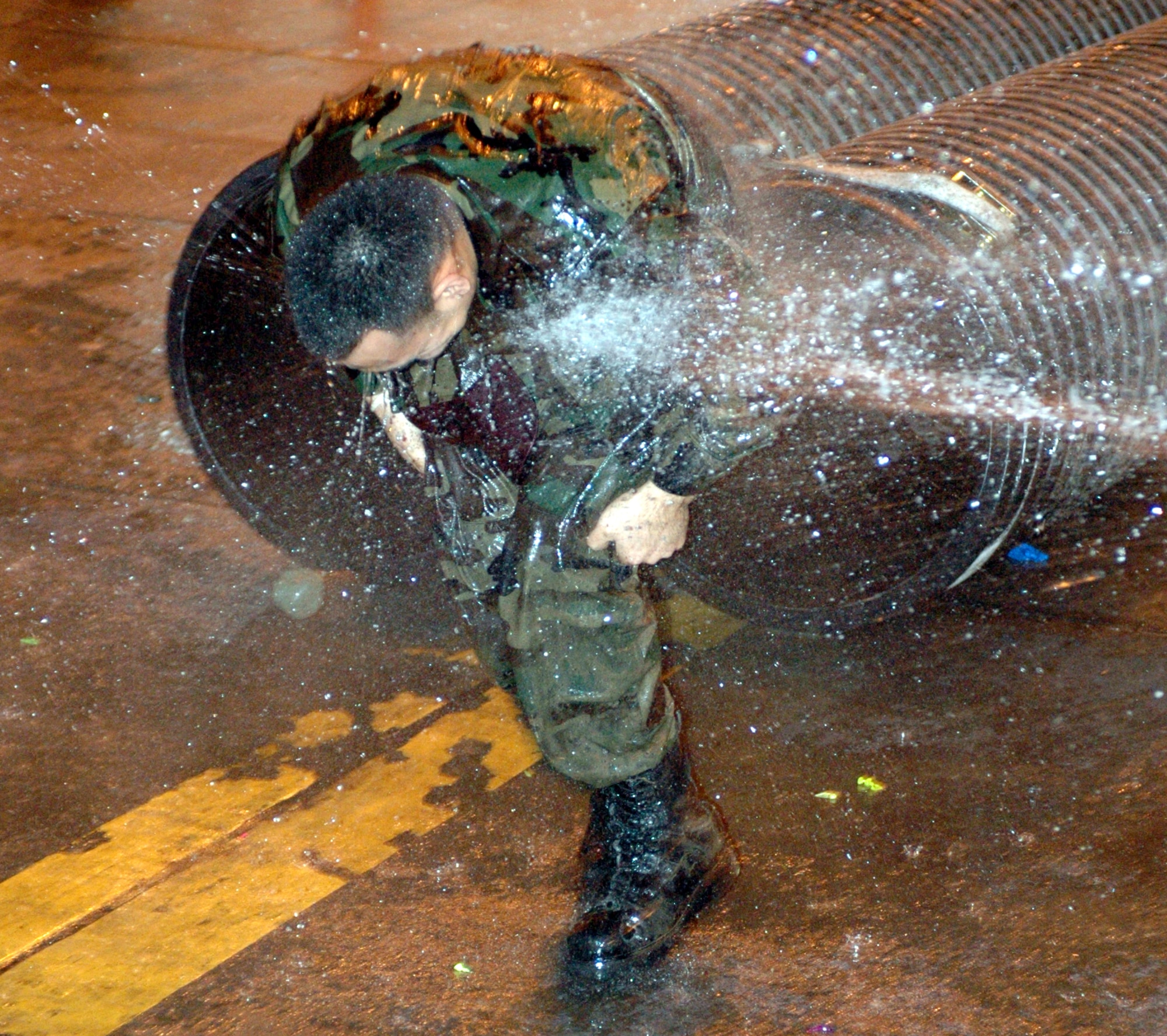 Before approaching the Grog, Airmen “convicted of breaking the rules of engagement” had to complete an obstacle course where their fellow Airmen were allowed to soak them with water. (U.S. Air Force photo by Staff Sgt. Candy Knight)